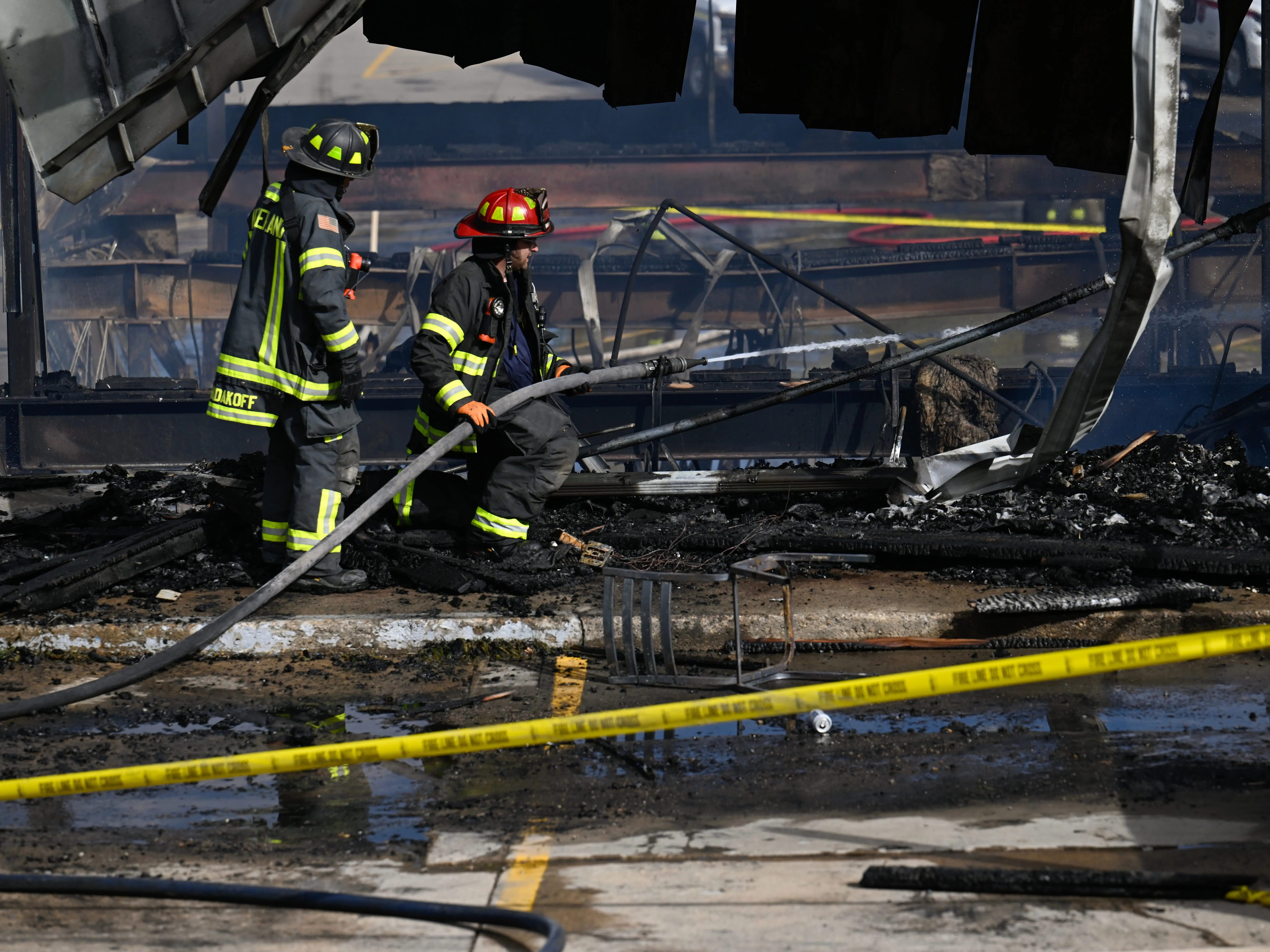 Firefighters in the wreckage of a fire extinguishing hot spots in Nederland, Colorado.