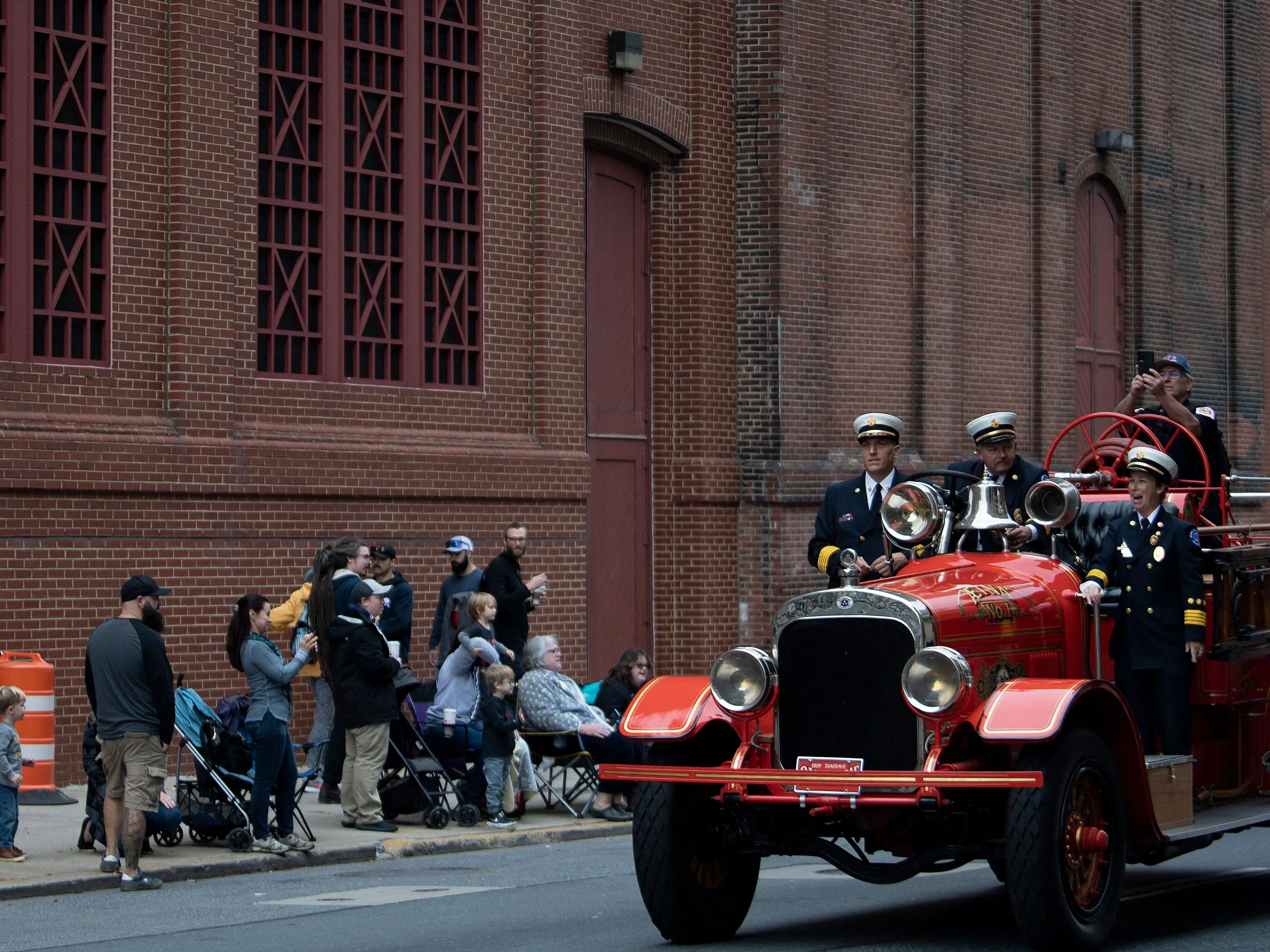 Spectators watching an old-fashioned firetruck as the Wilmington Fire Department celebrates its 100th anniversary in Wilmington, Delaware.