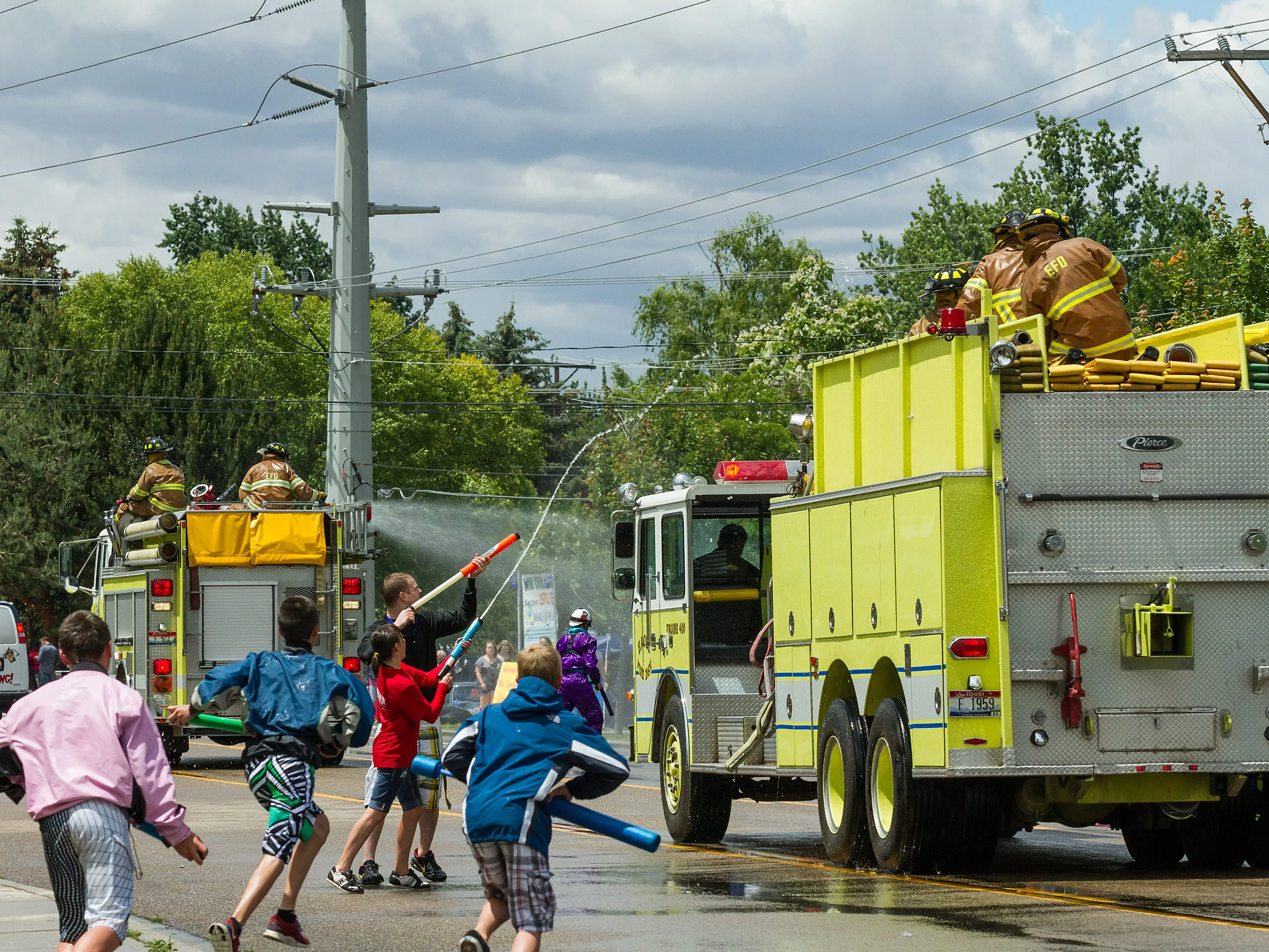 Children squirt water at firefighters in Eagle, Idaho.