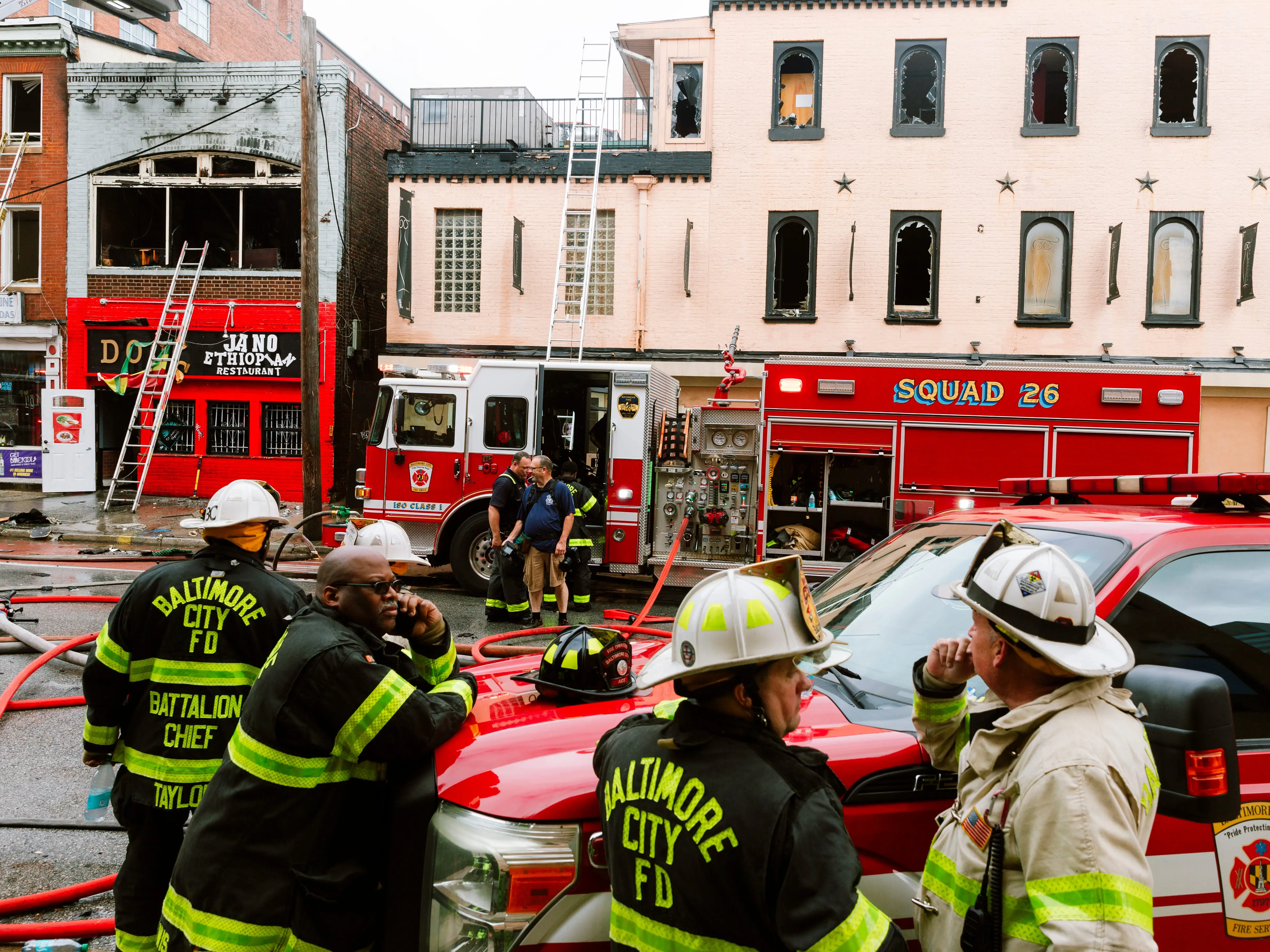 Firefighters gather in front of vehicles during a response in Baltimore, Maryland.