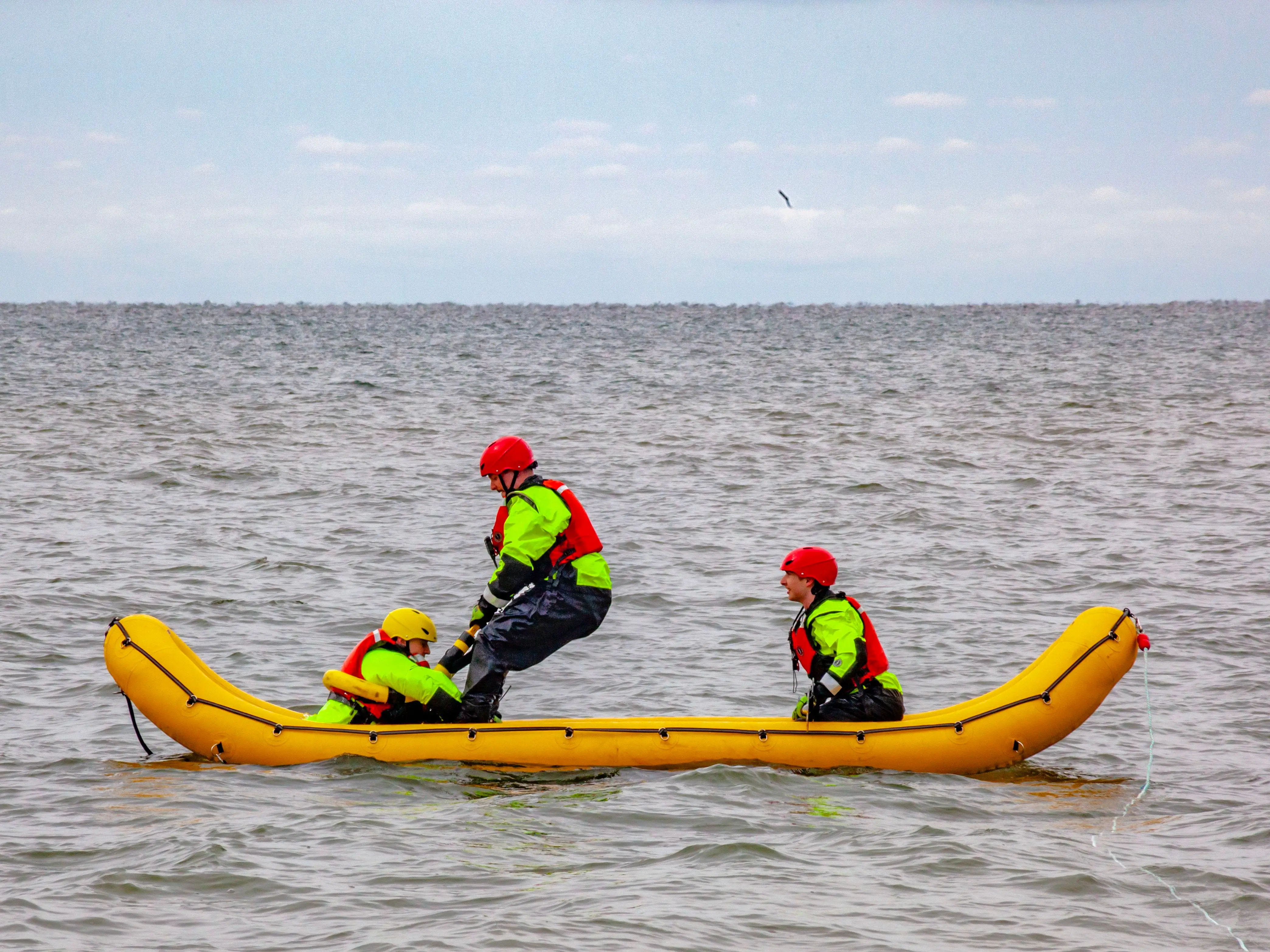 Three firefighters practicing a water rescue on Lake St. Clair near Harrison Township, Michigan.