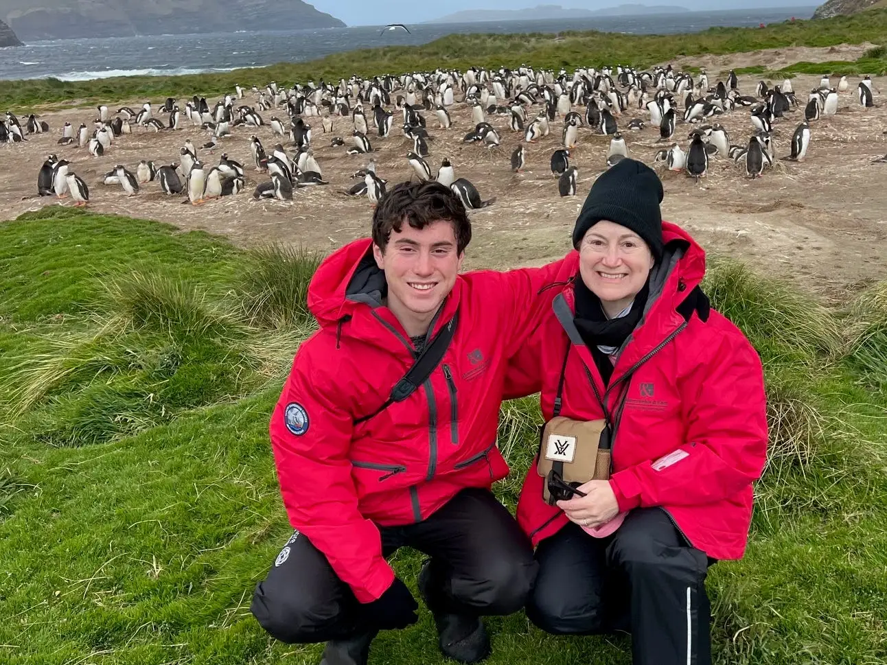 Mom and son posing with penguis