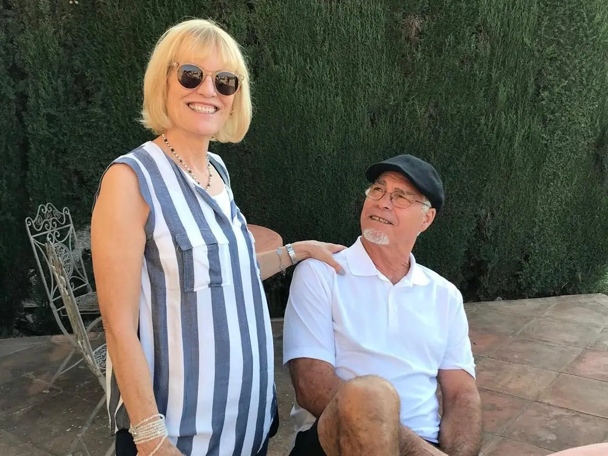 The author's grandparents posing for a photo together.