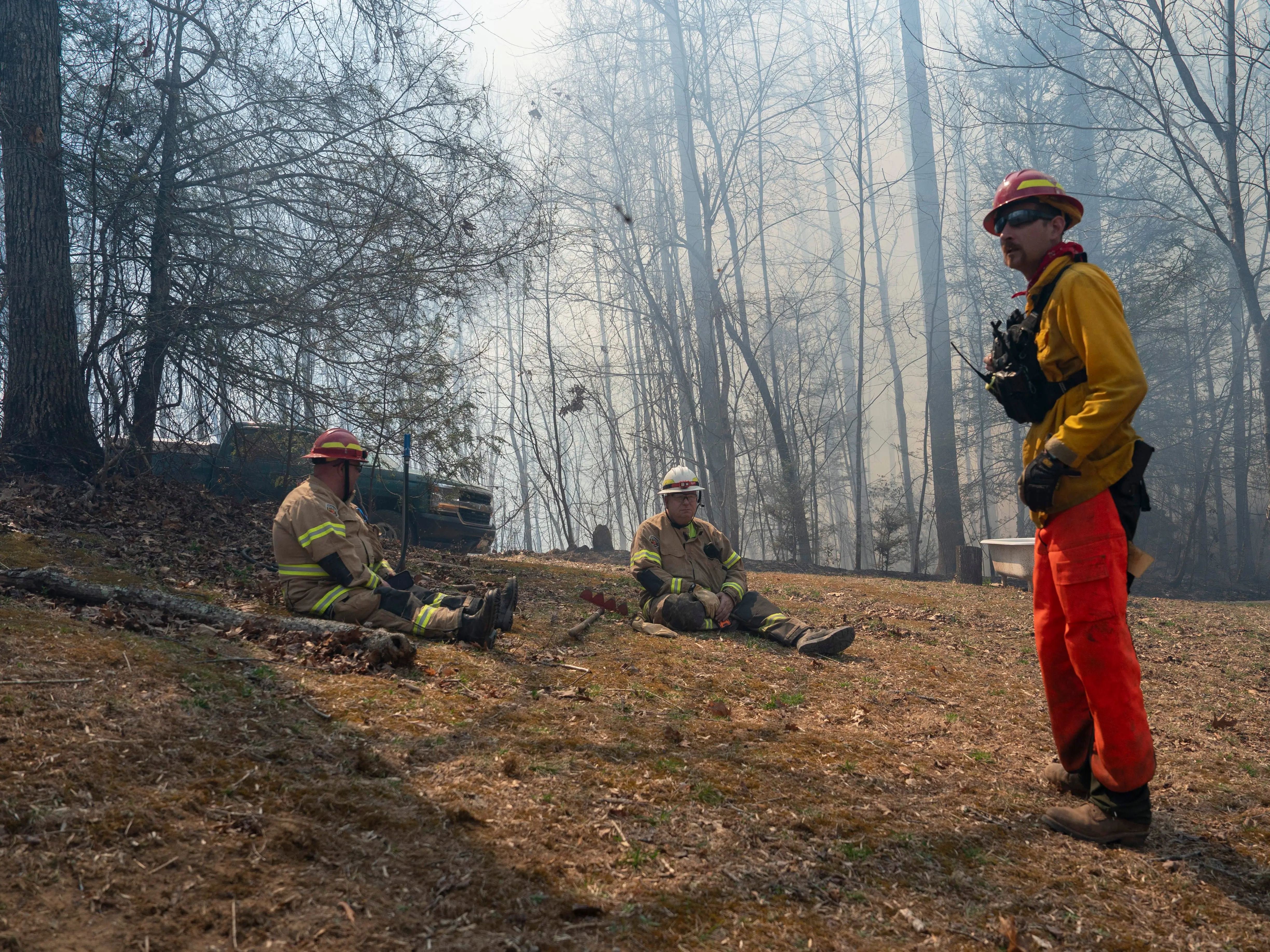 Firefighters take a break after responding to a wildfire in  Saluda, North Carolina.