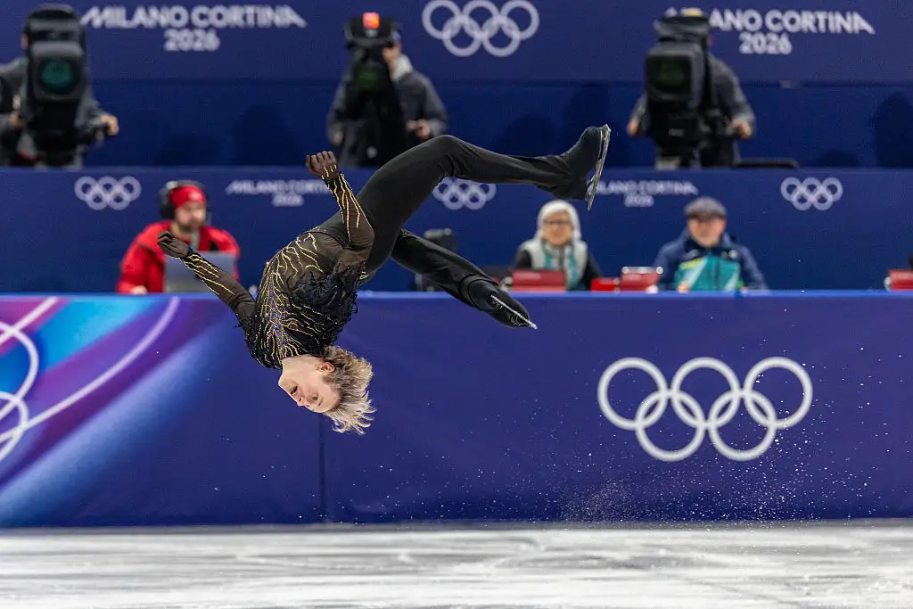 Ilia Malinin backflips on the ice.