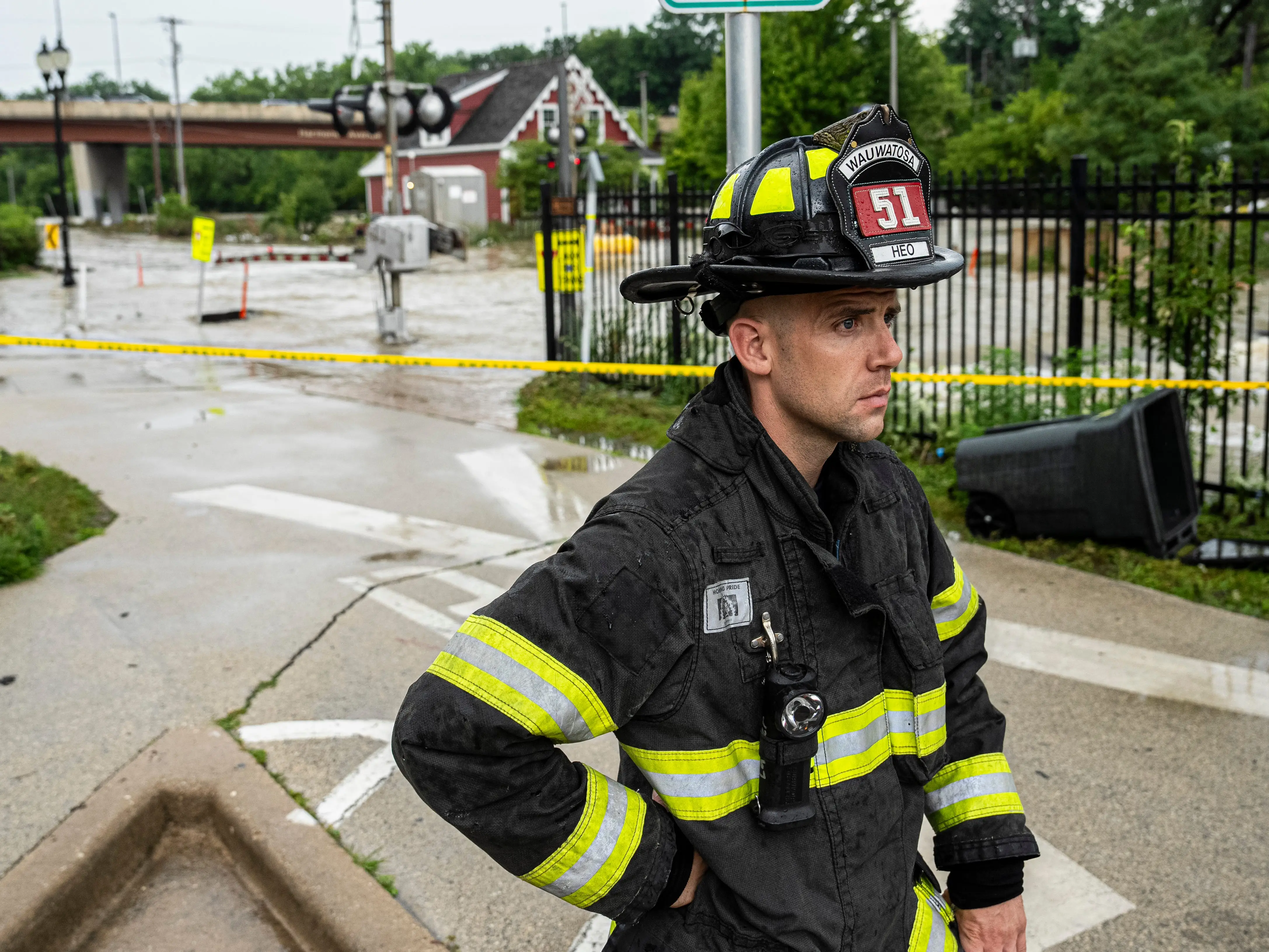 A firefighter observes flooding in Wauwatosa, Wisconsin.
