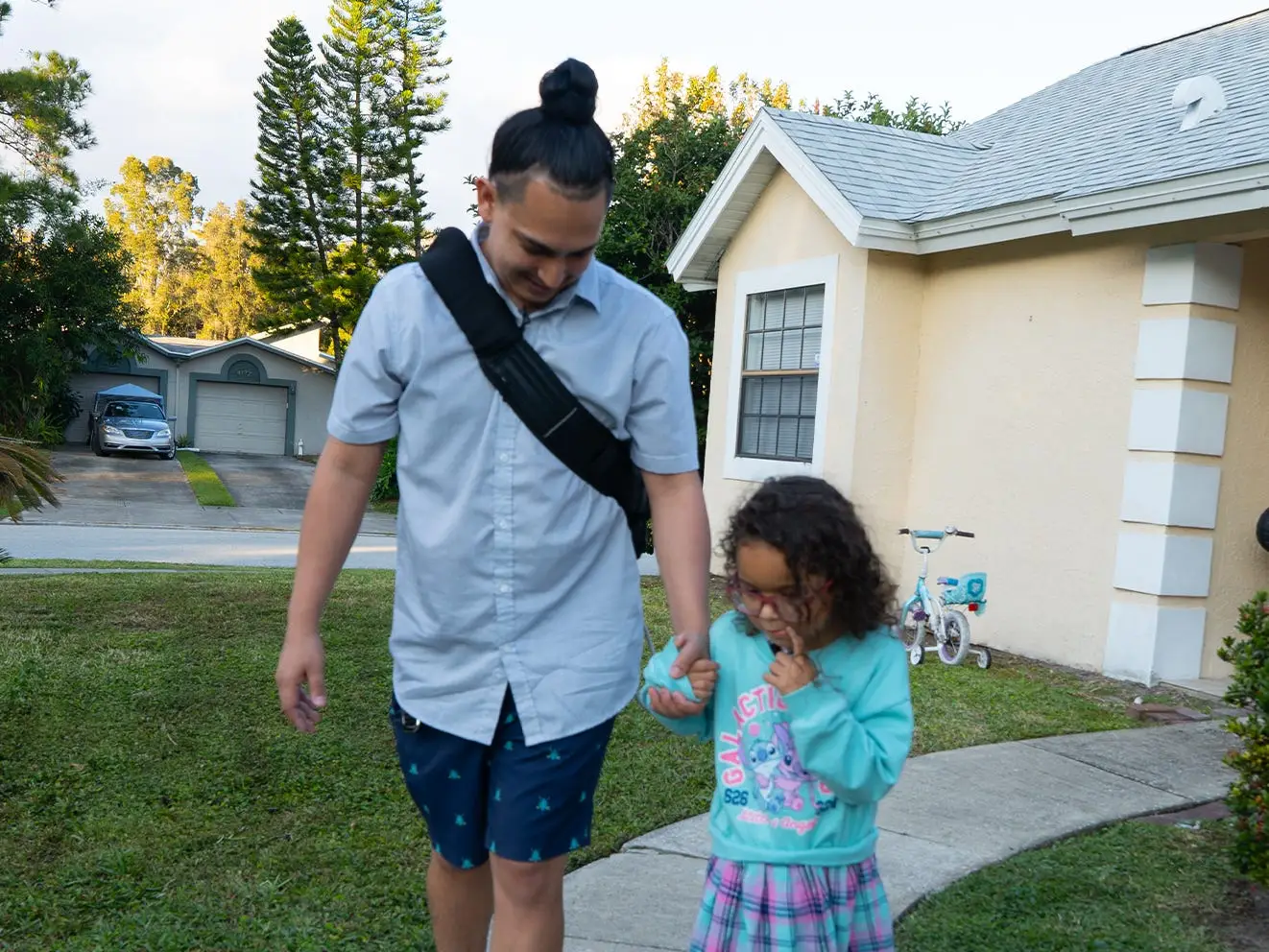 A man walking outside with his 6-year-old daugther