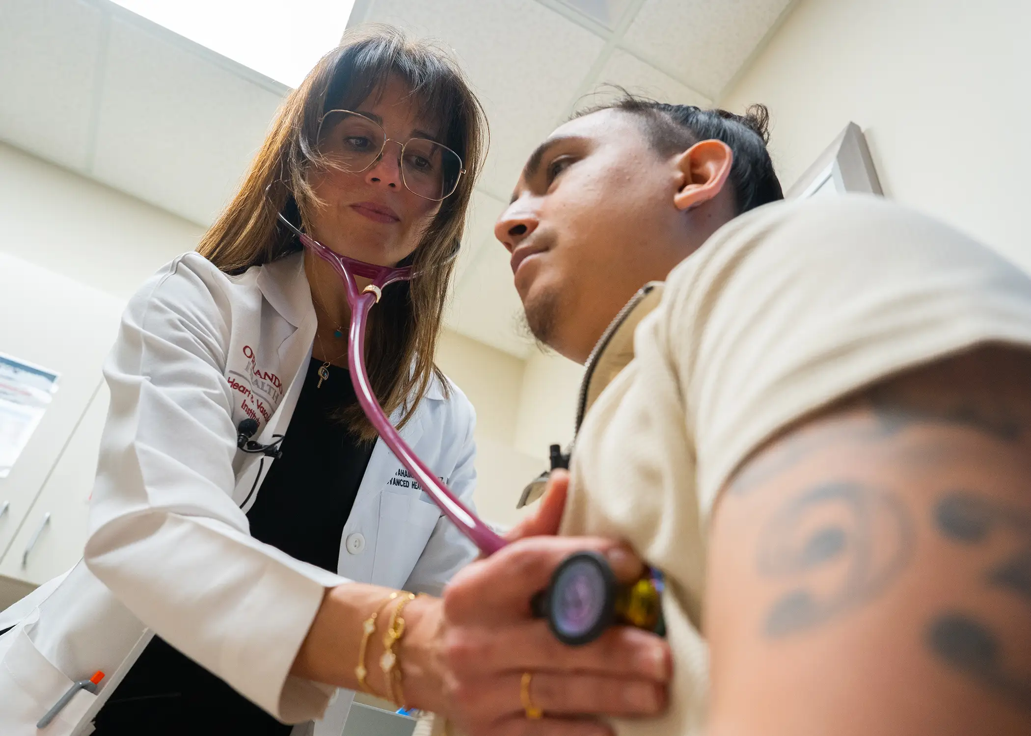 A doctor checking the heart health of a patient with a stethoscope