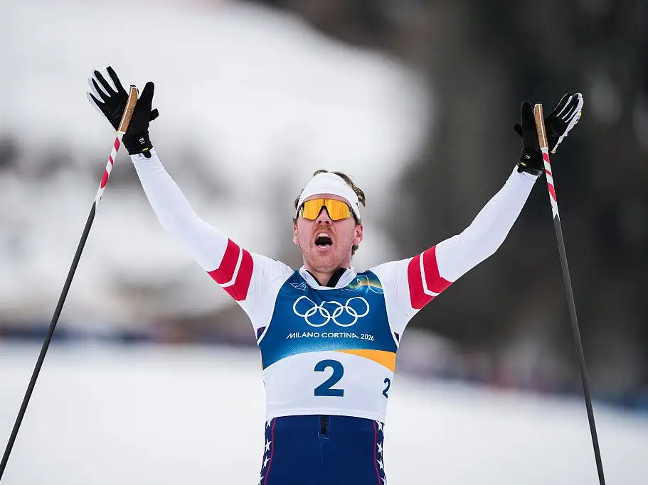 Ben Ogden celebrates after the finish line of the Men's Sprint Classic on day four of the Milano Cortina 2026 Winter Olympic Games.
