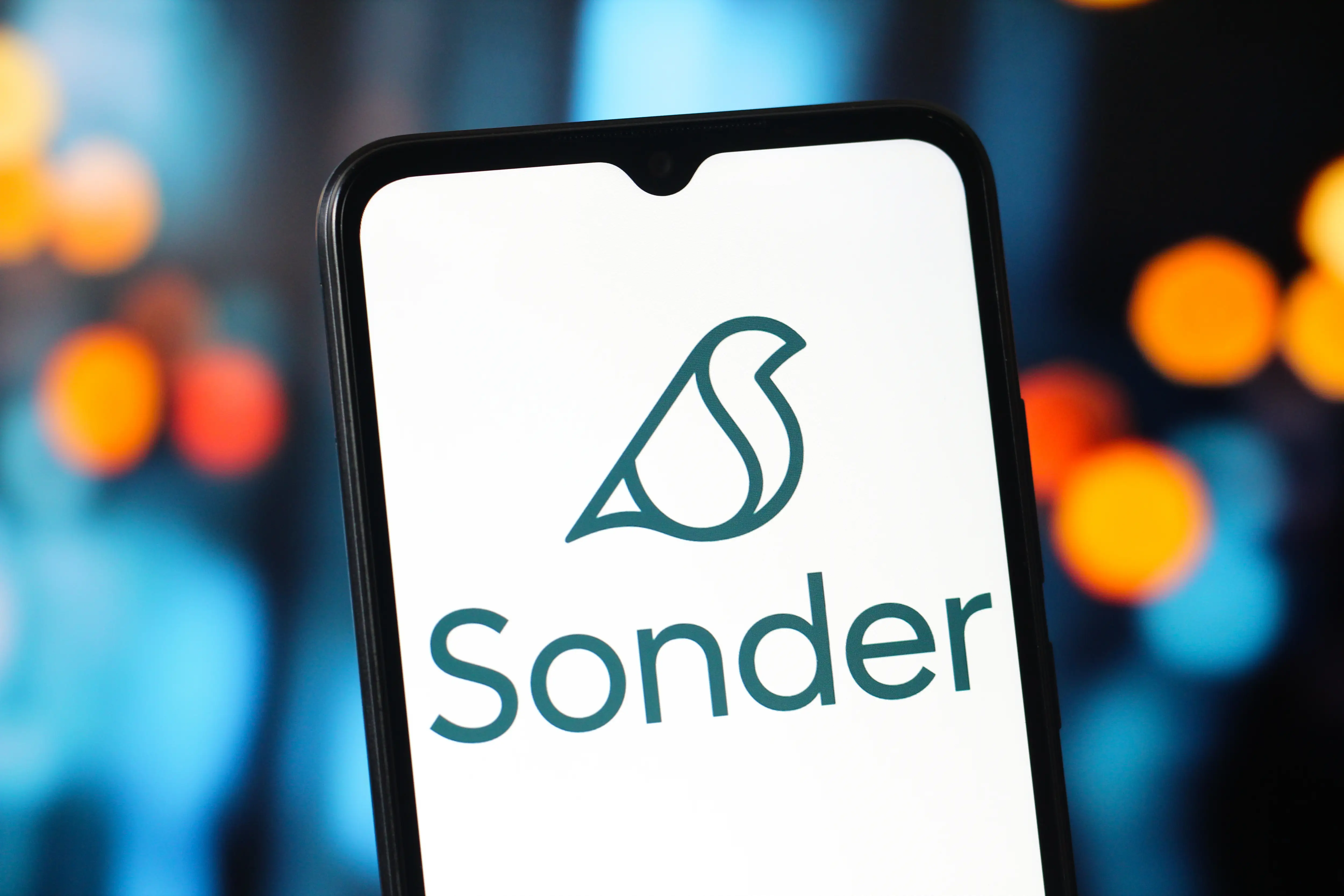 The Sonder Holdings logo is displayed on a smartphone screen.