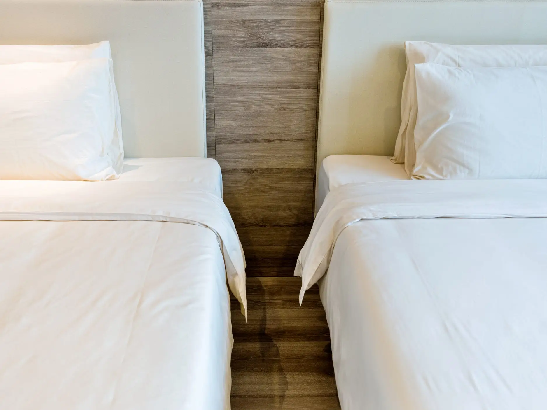 Two beds in a hotel room.