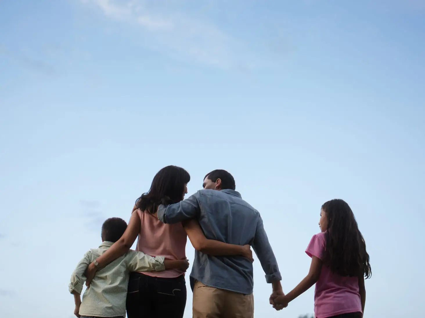 Family holding hands together.
