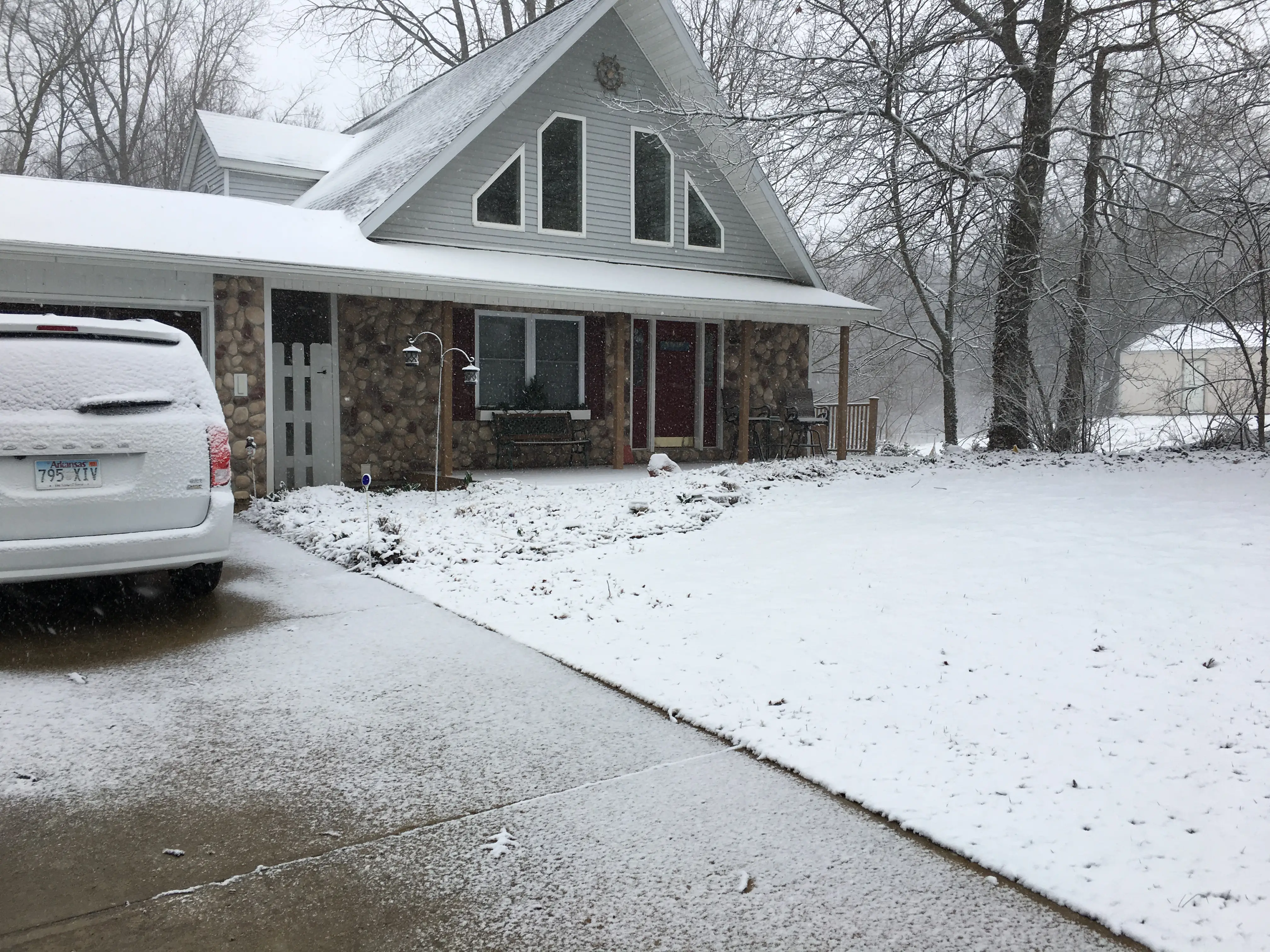 Snow-covered driveway of a house in Michigan.