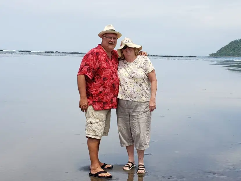A man and woman standing on the beach in Panama.