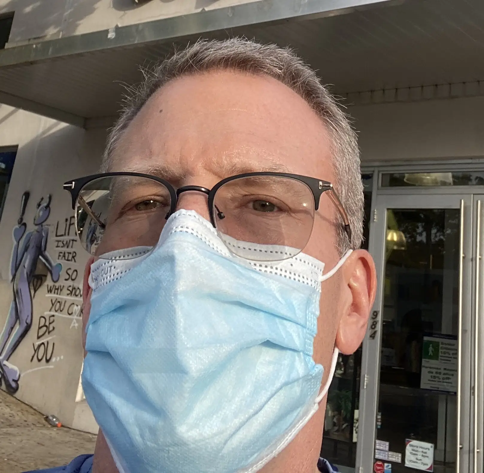 Scott Scovel is wearing a blue face mask during the COVID-19 pandemic.