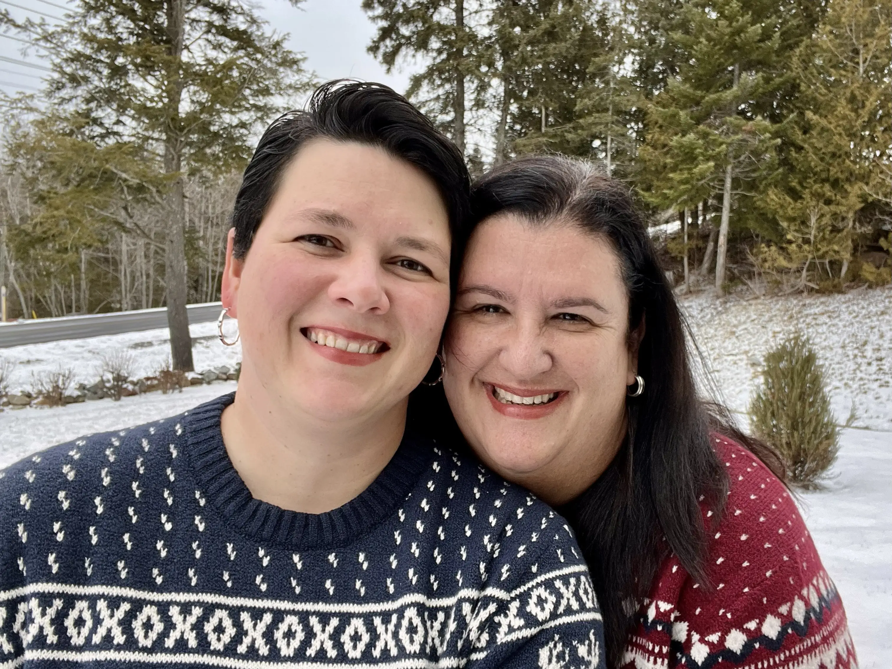 Author Tara Pyfrom and wife smiling in sweaters