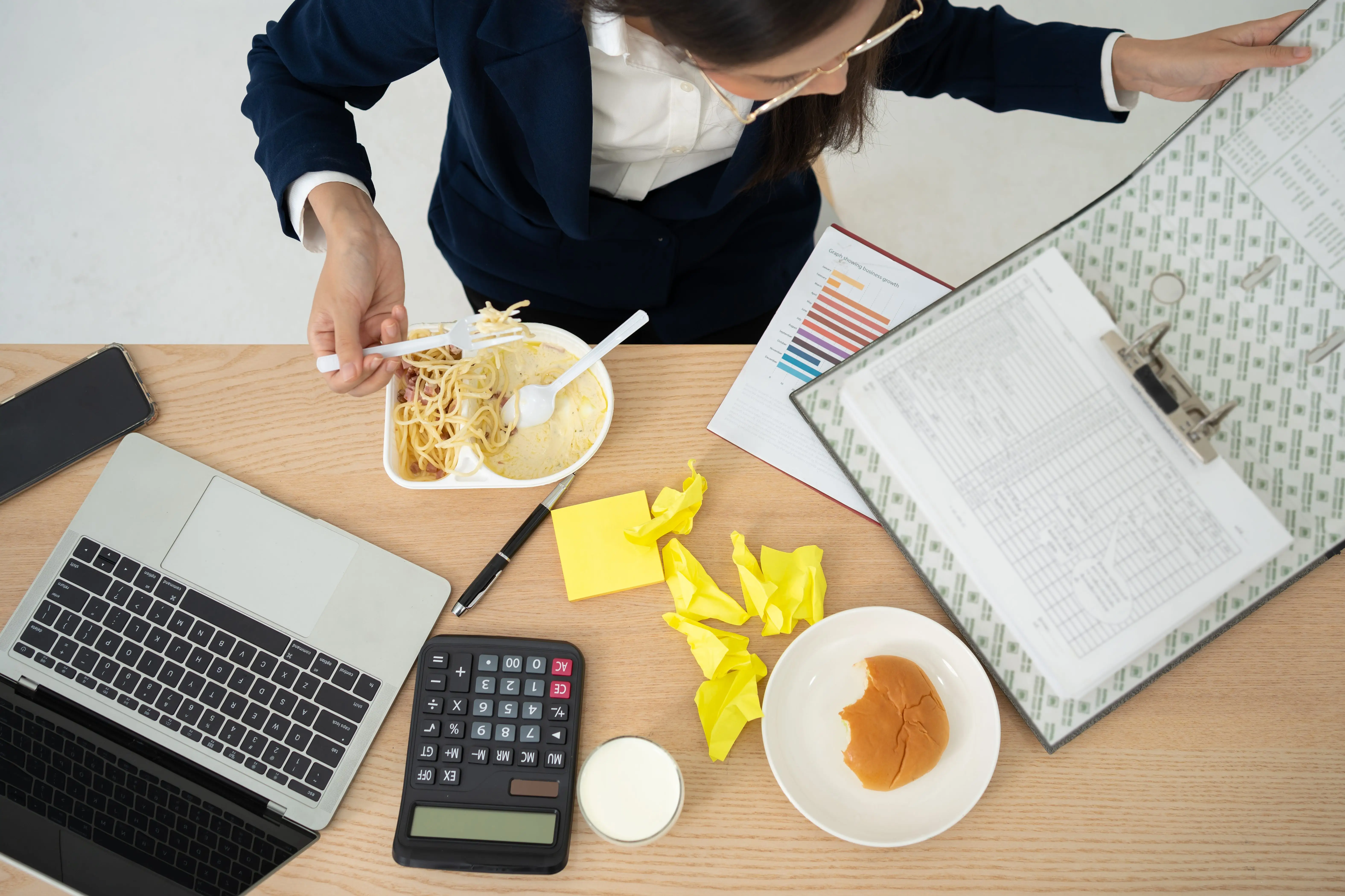 Woman eating dinner at desk