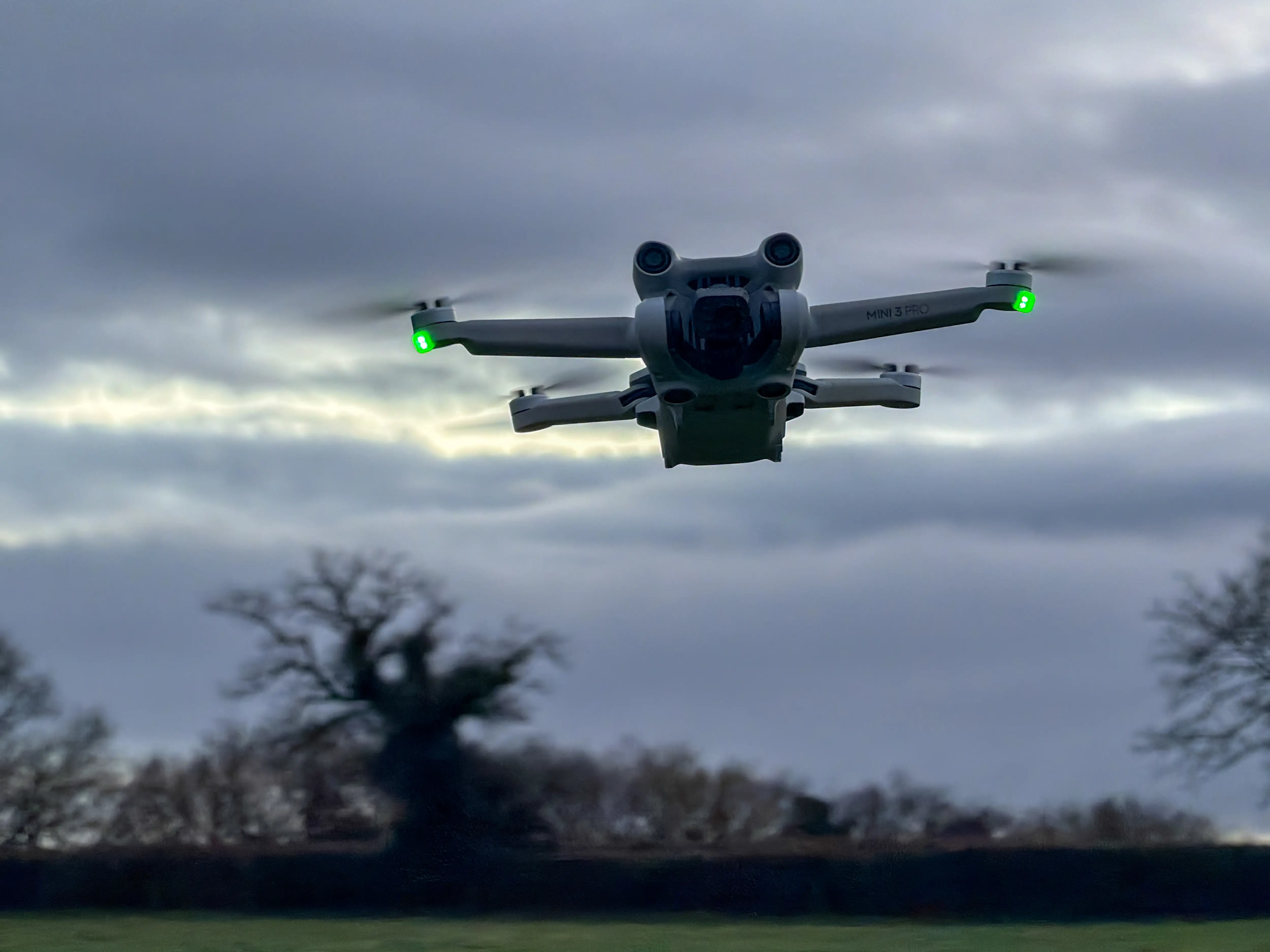 A DJI Mini 3 drone flies above the ground on February 8, 2026, in Radstock, England.