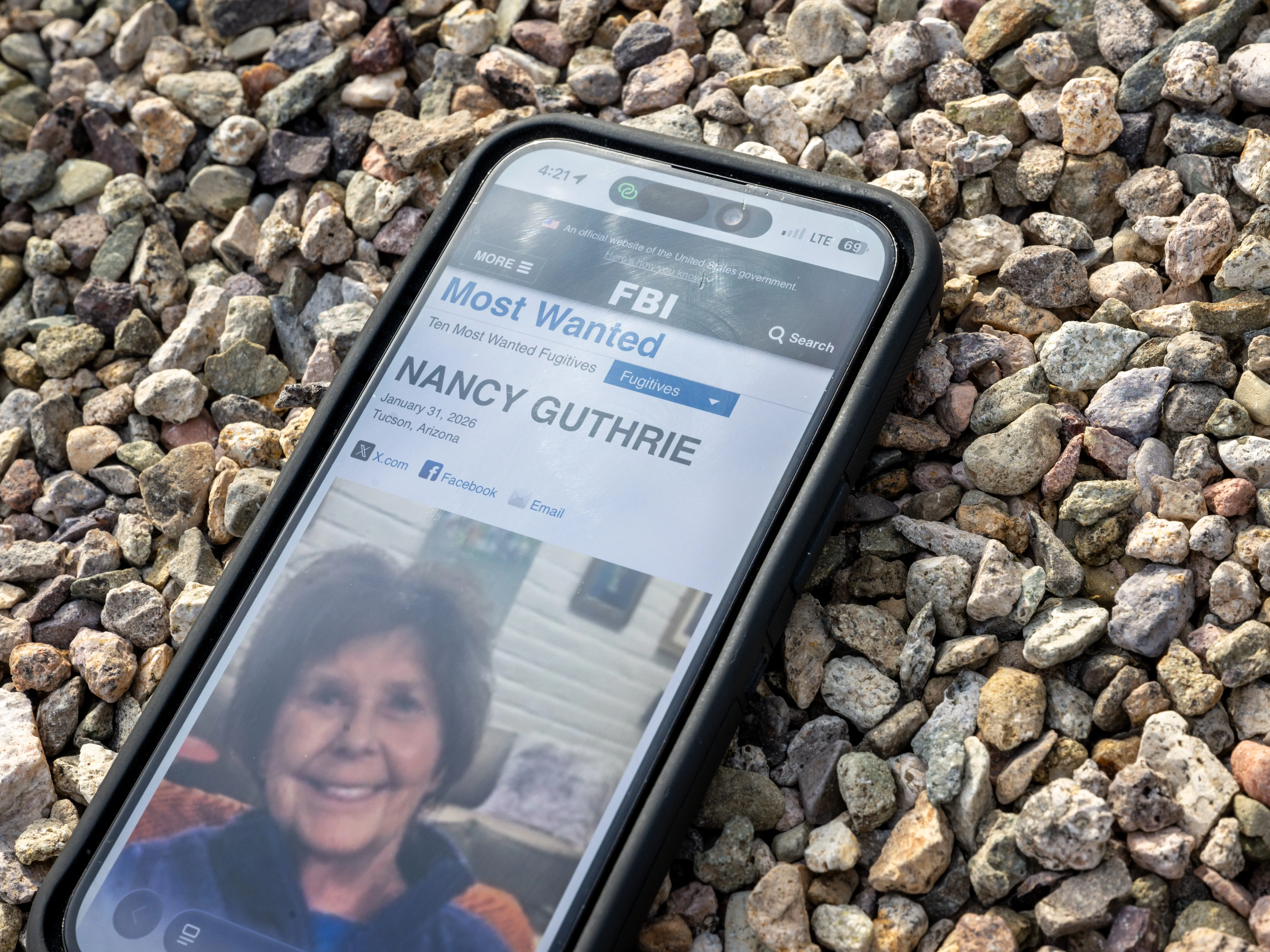 Phone showing FBI search page for Nancy Guthrie