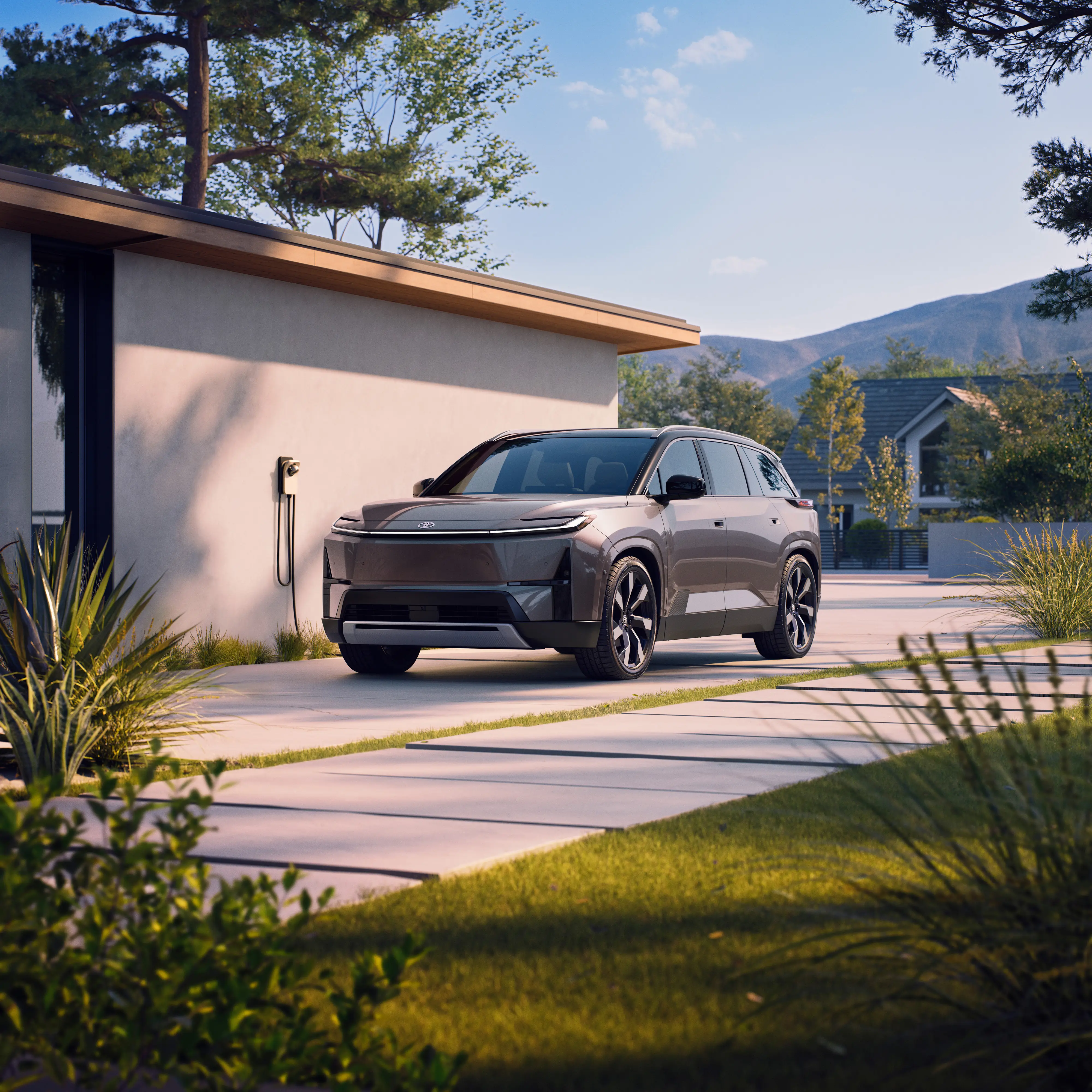 A Toyota Highlander EV plugged into a modern home.