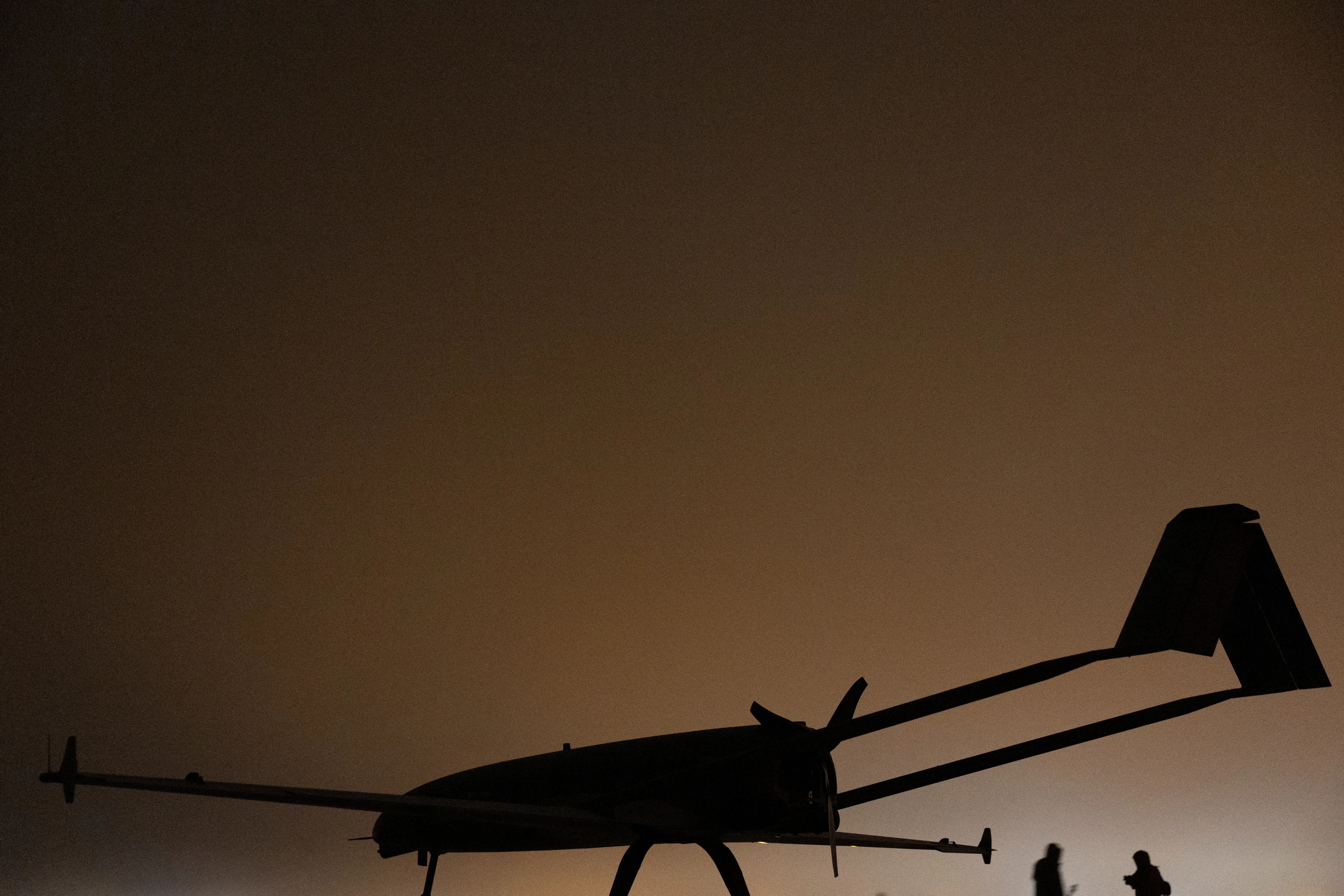 Ukrainian service members of the 14th Unmanned Aerial Systems Regiment stand next to a deep strike unmanned aerial vehicle before its launch toward Russian territory, amid Russia's attack on Ukraine, in an undisclosed location in Ukraine, undisclosed date, 2025.