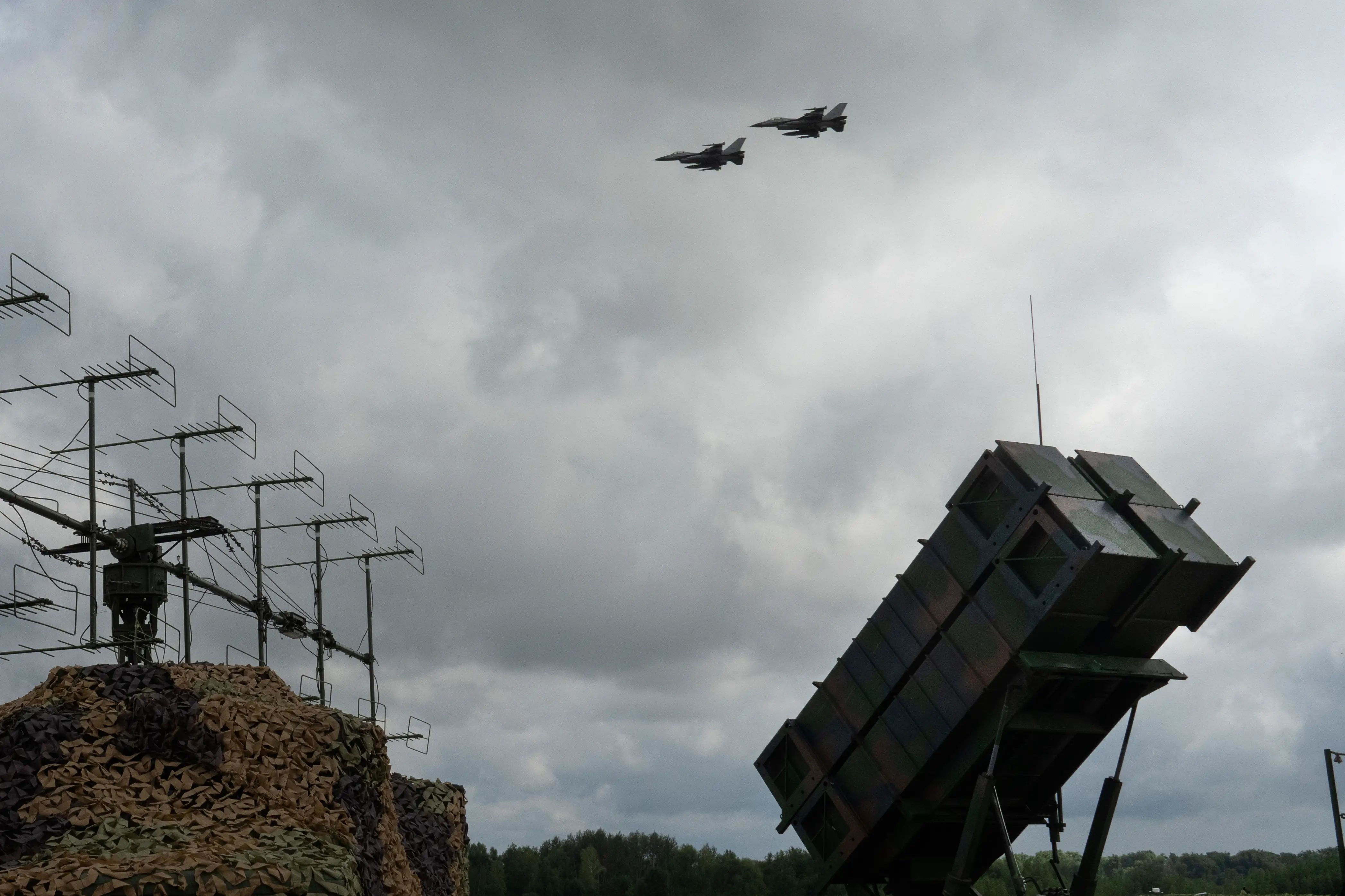 The Ukrainian Air Force's F-16 fighter jets fly over a Patriot Air and Missile Defense System in an undisclosed location in Ukraine, Sunday, August 4, 2024.