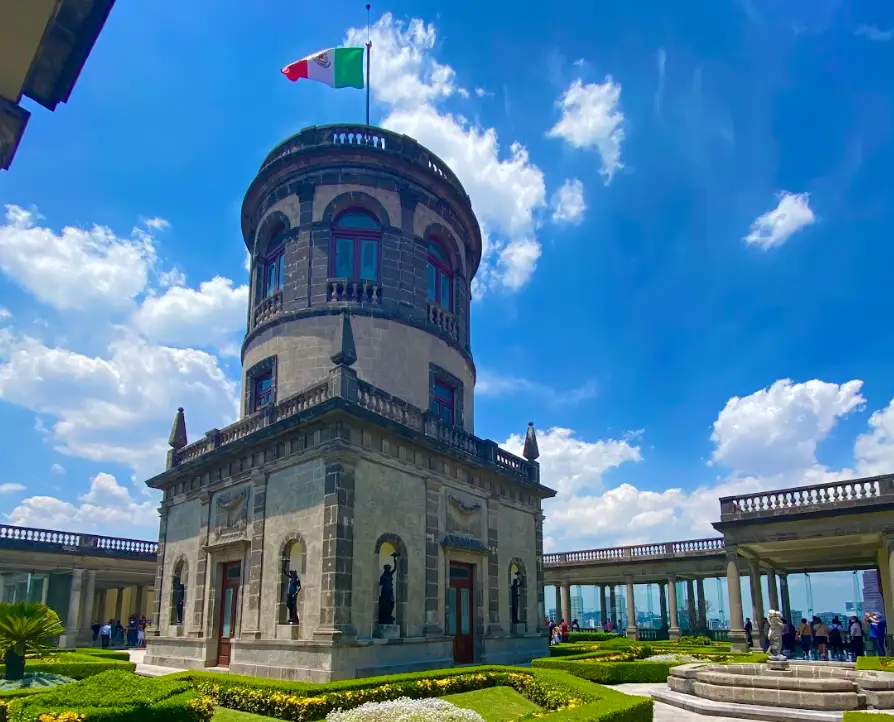 A shot of a building and Mexican flag in Mexico City.