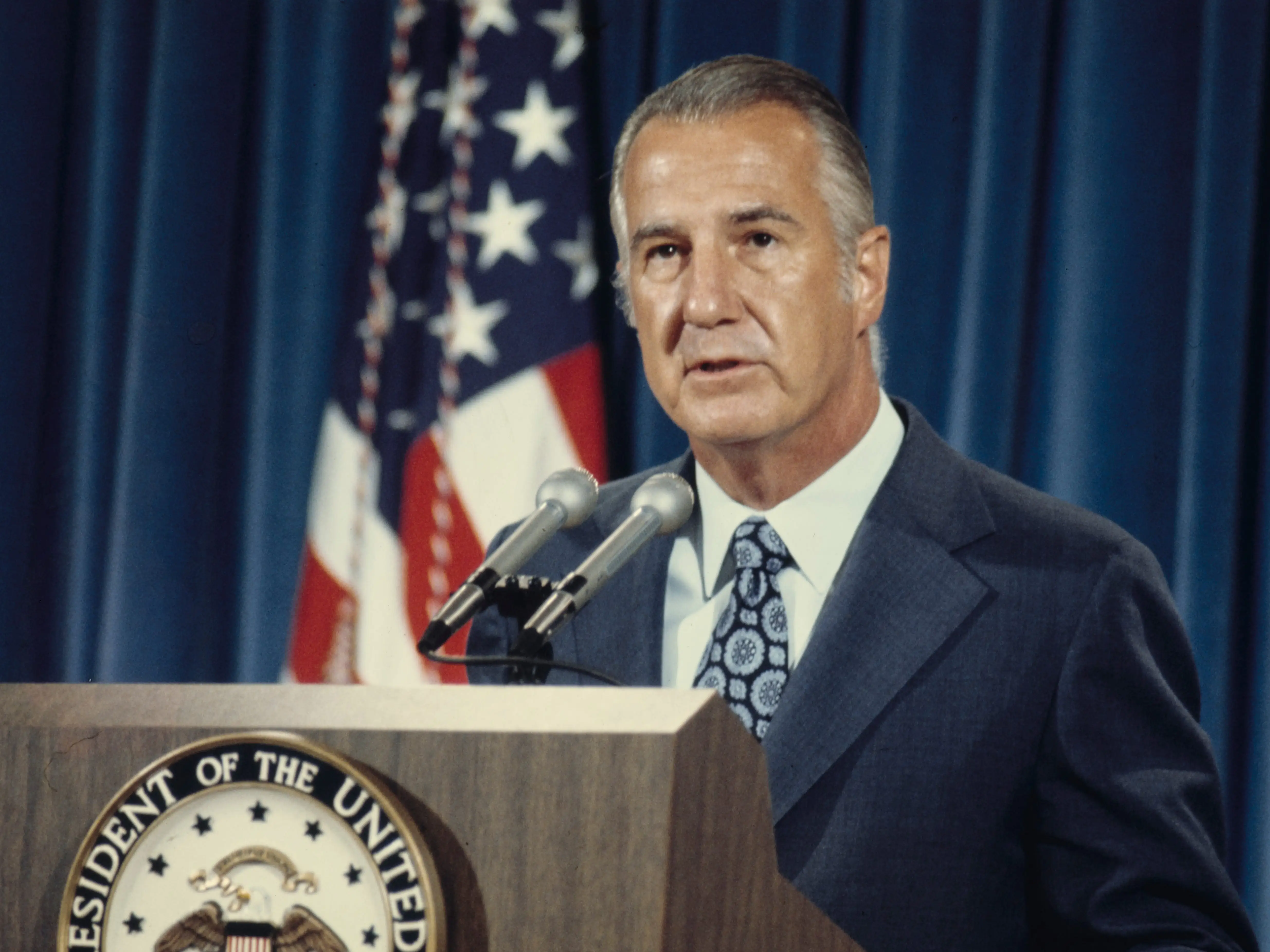 Spiro Agnew speaking at a podium.