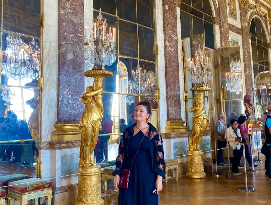 The writer roaming a hallway in Versailles.