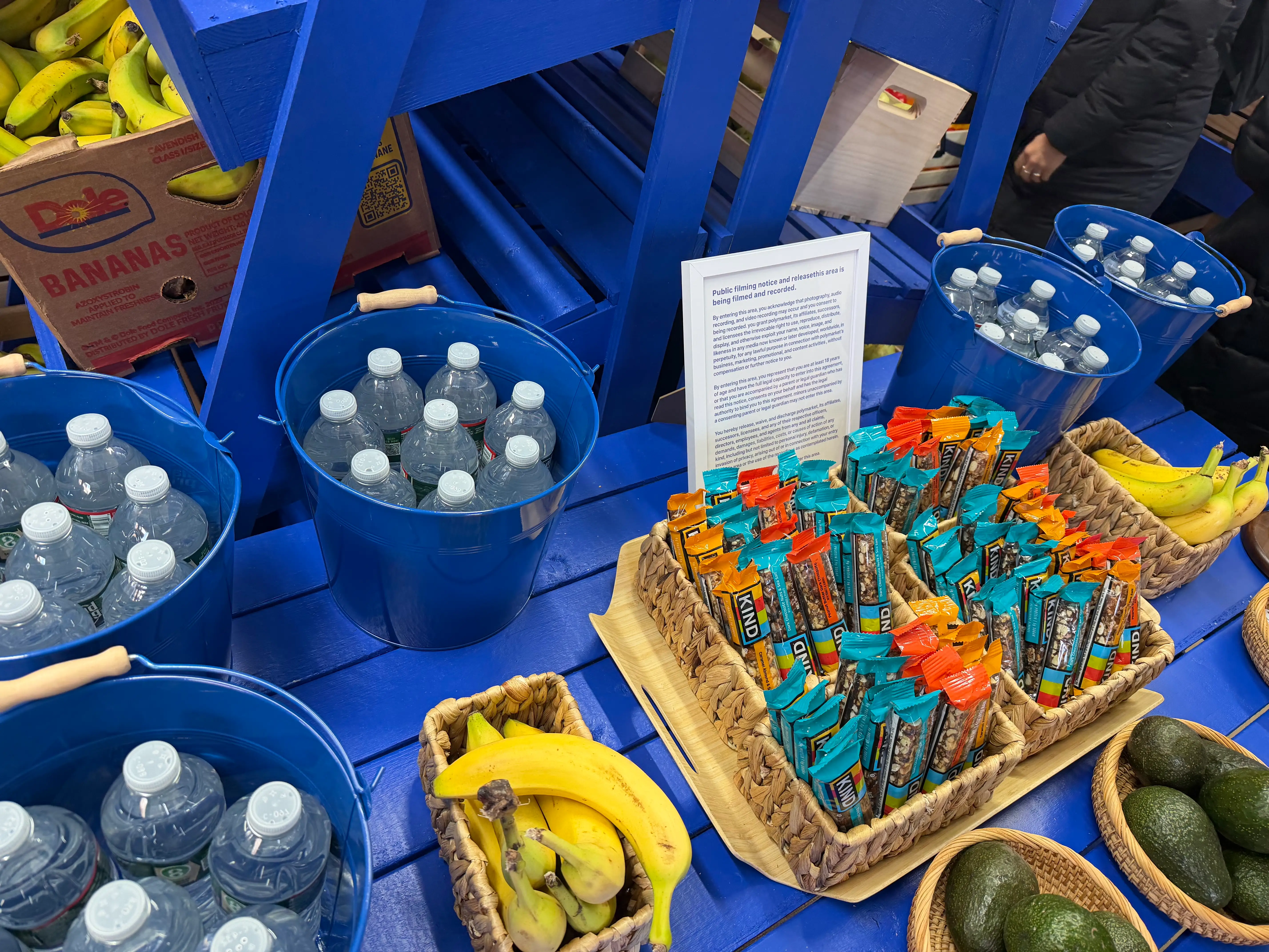 A sign at the Polymarket demonstrating that we are being recorded is pictured.