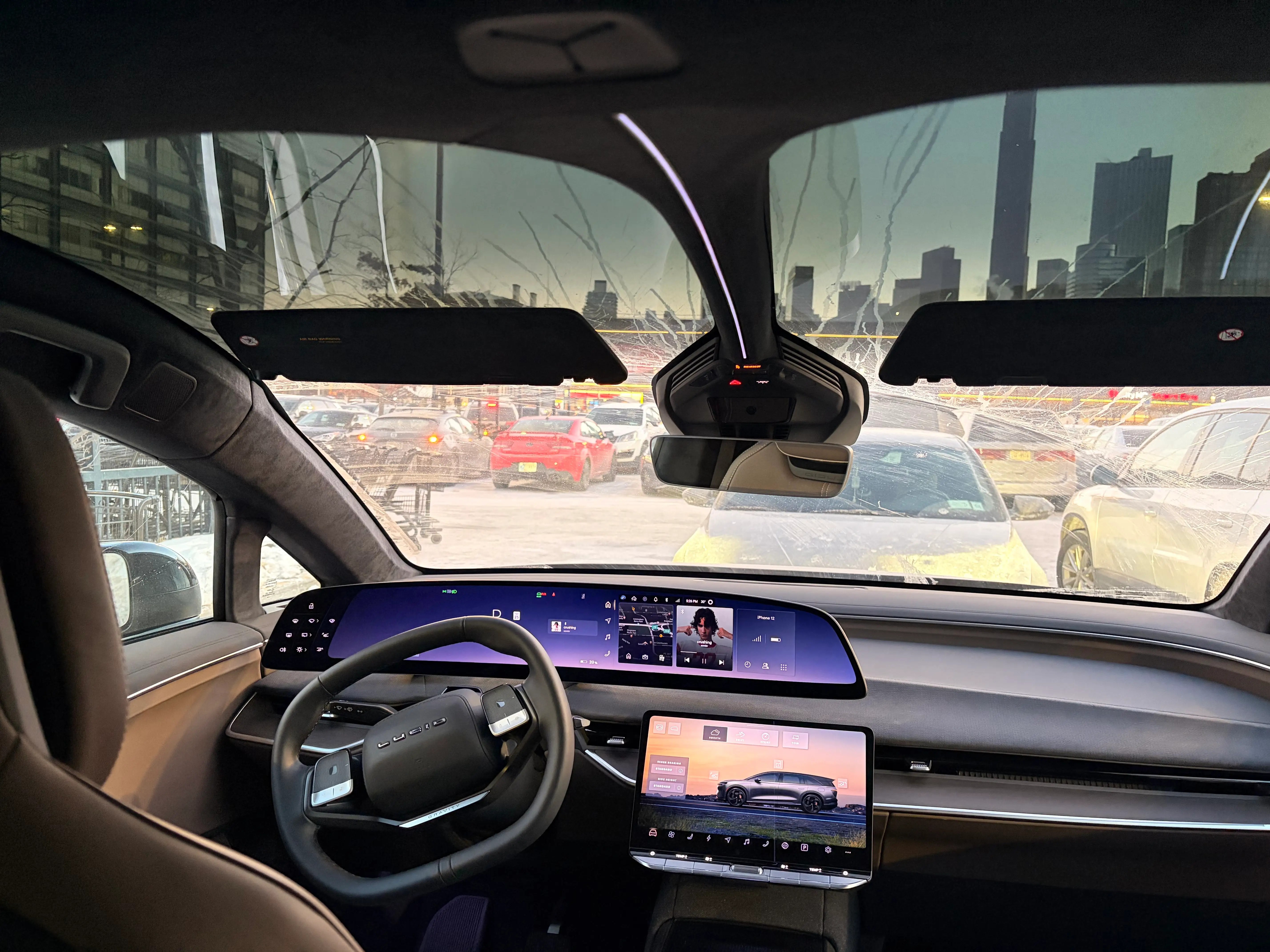 Inside a Lucid Gravity - in the front row, it has two large screens and a squared-off steering wheel.
