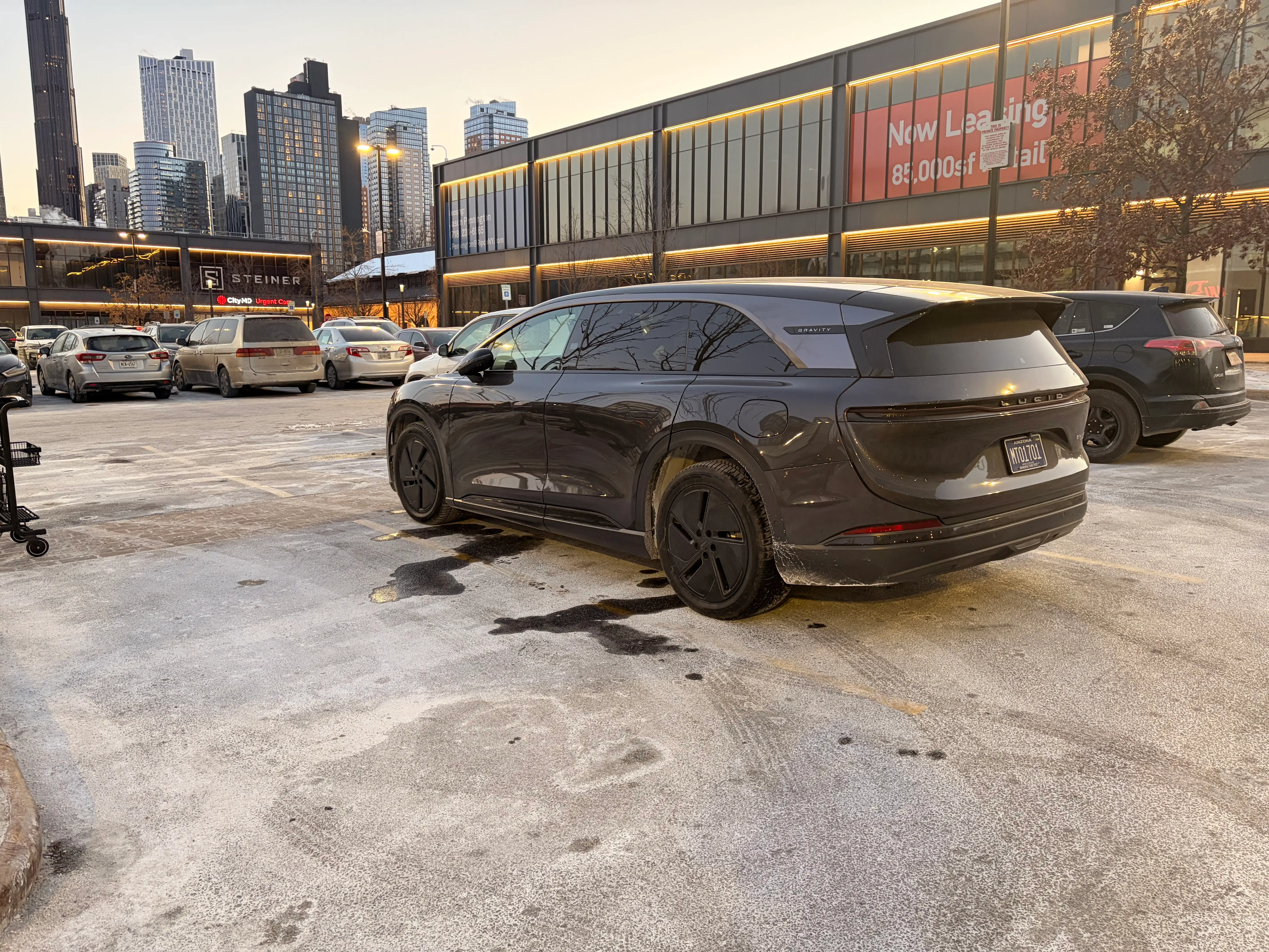 The back of a Lucid Gravity - it's parked in a New York City parking lot.