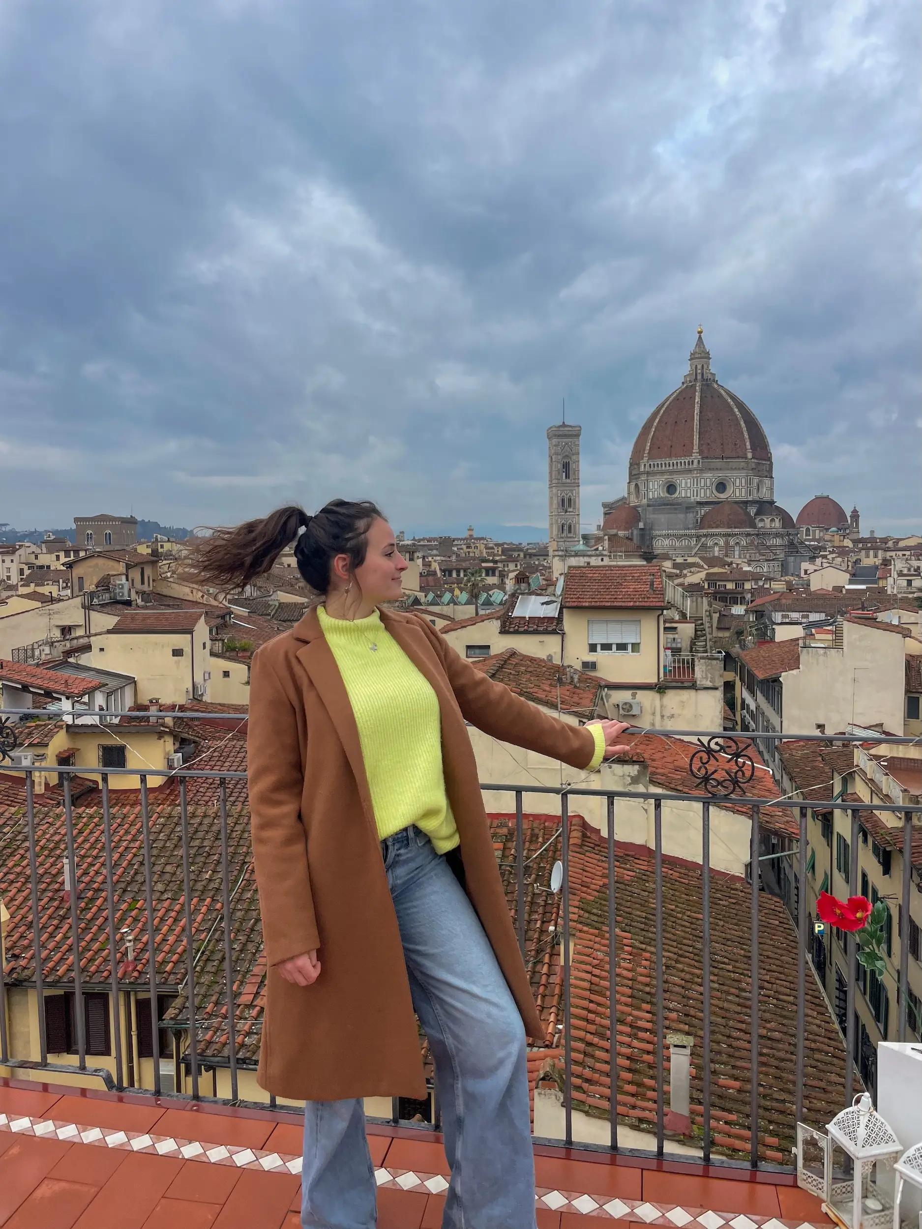 A woman overlooking a city in Italy.