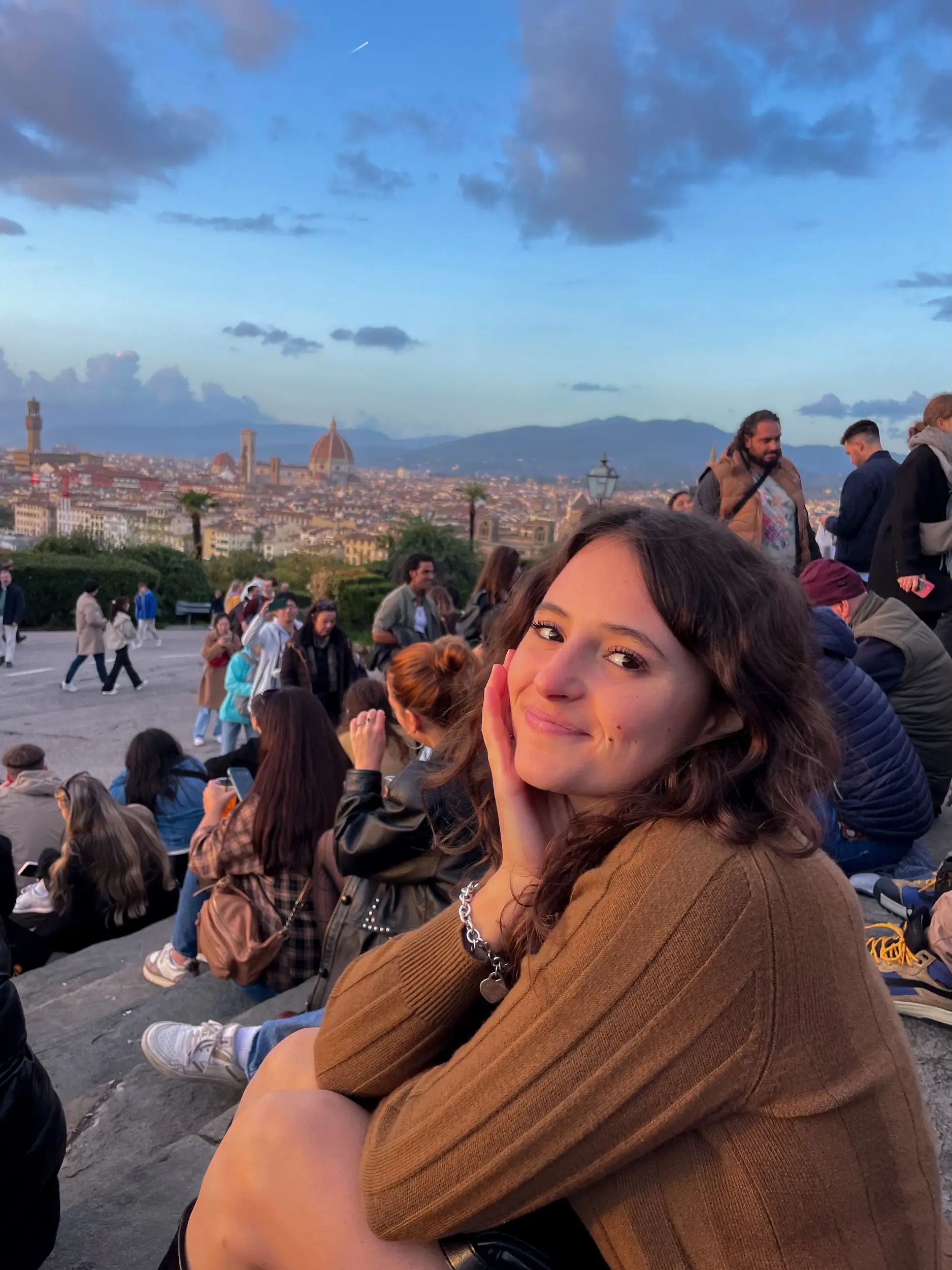 A woman posing seated in Italy.