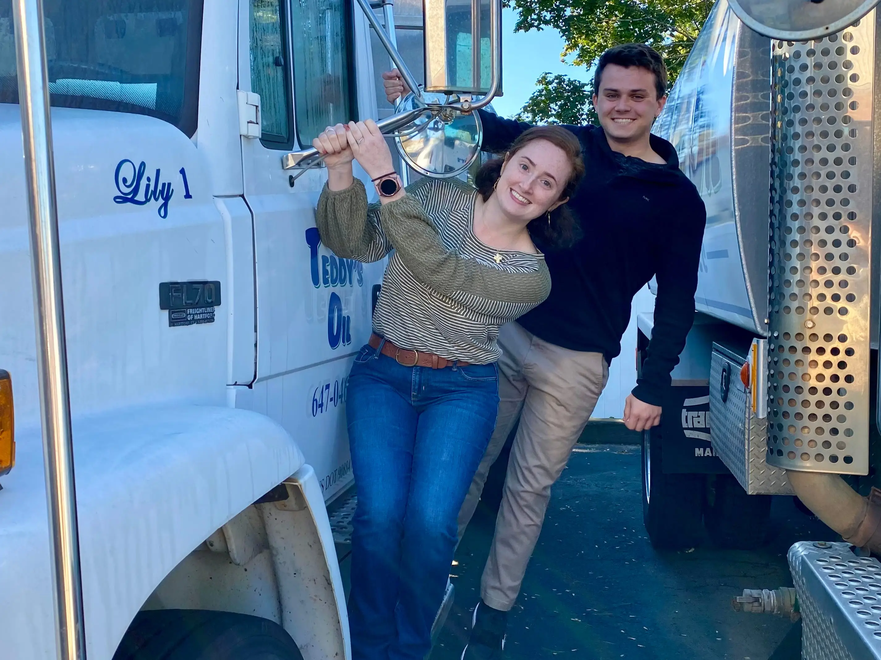 Teddy Rainville and his sister hanging off a company truck