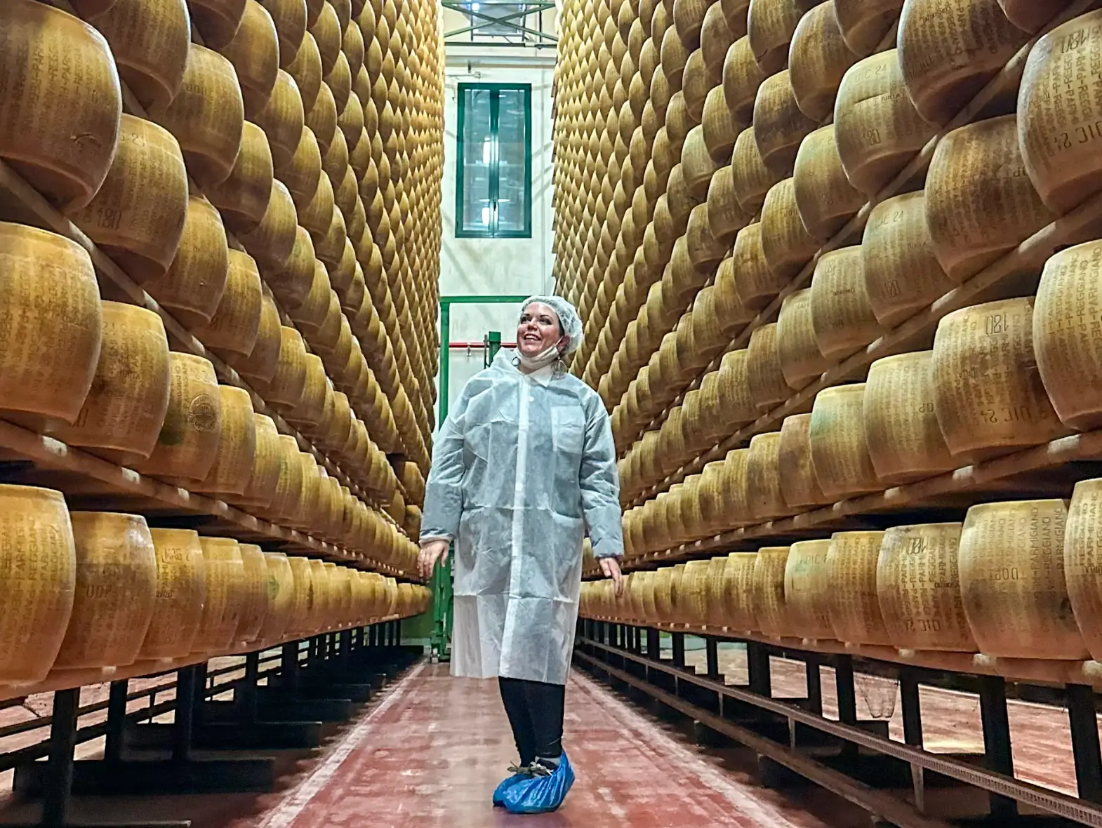 The writer standing at a Parmigiano-Romano dairy farm in Parma.