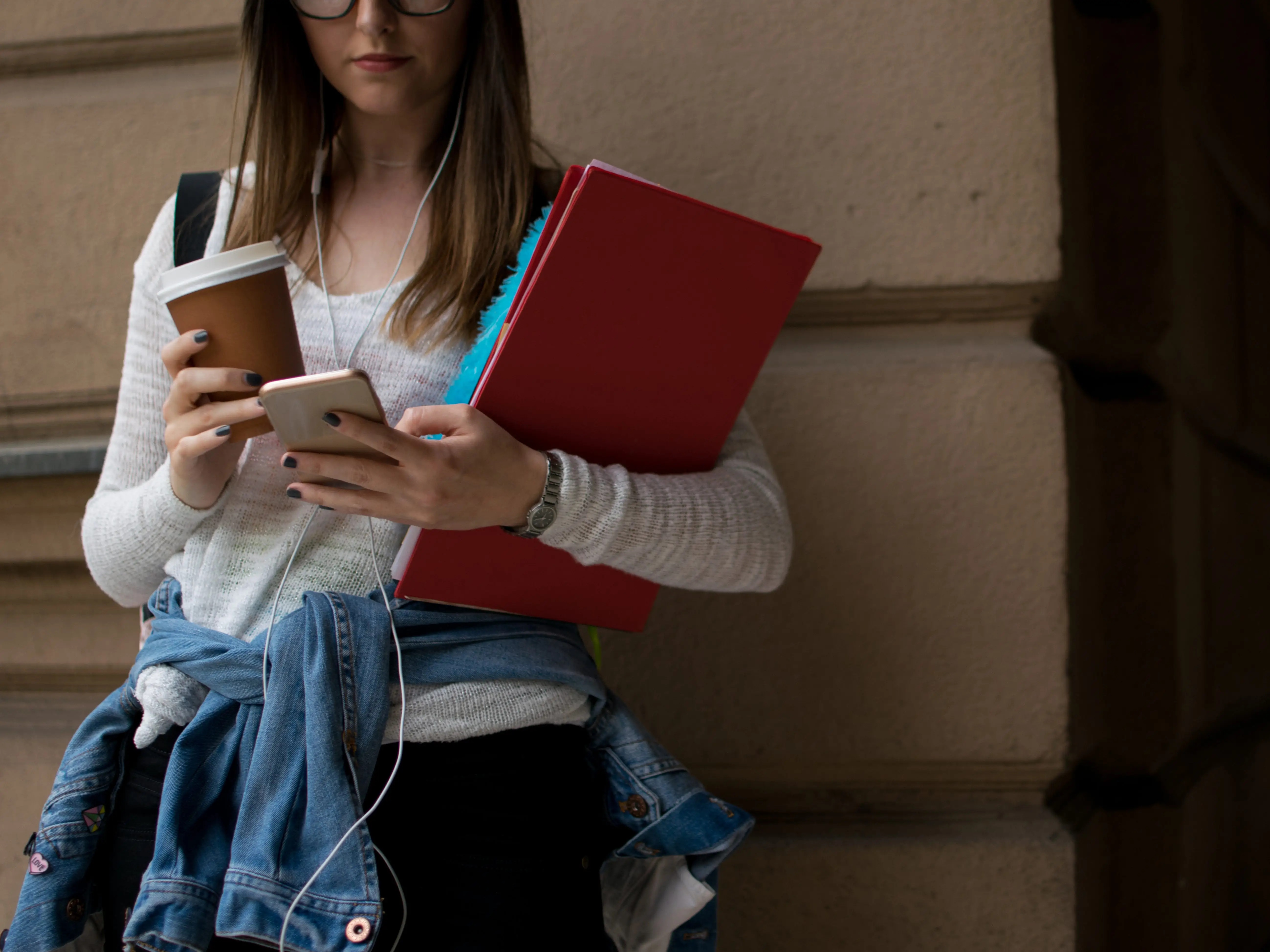 a female student looking at her phone on college campus