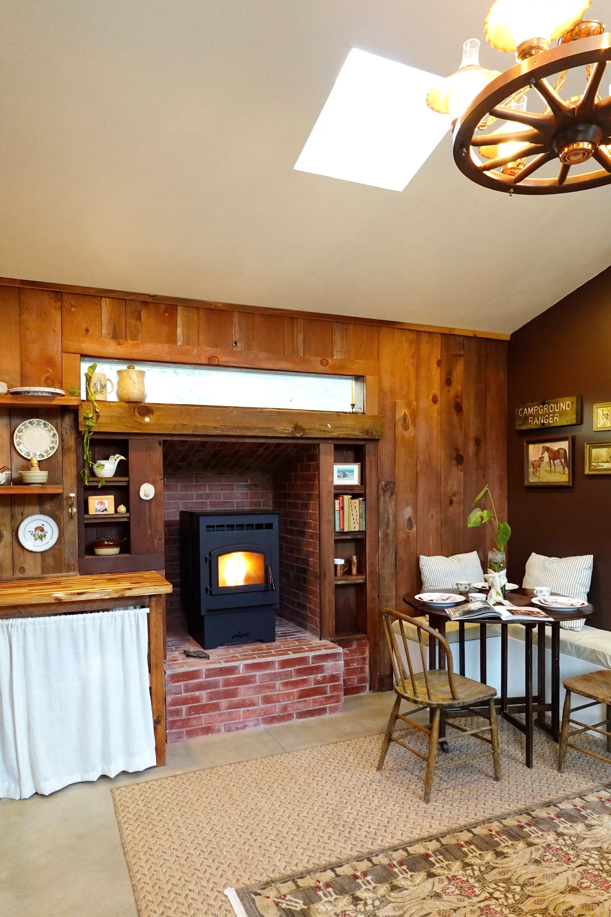 A home with a fireplace, bench seating, a table, and wood countertops.