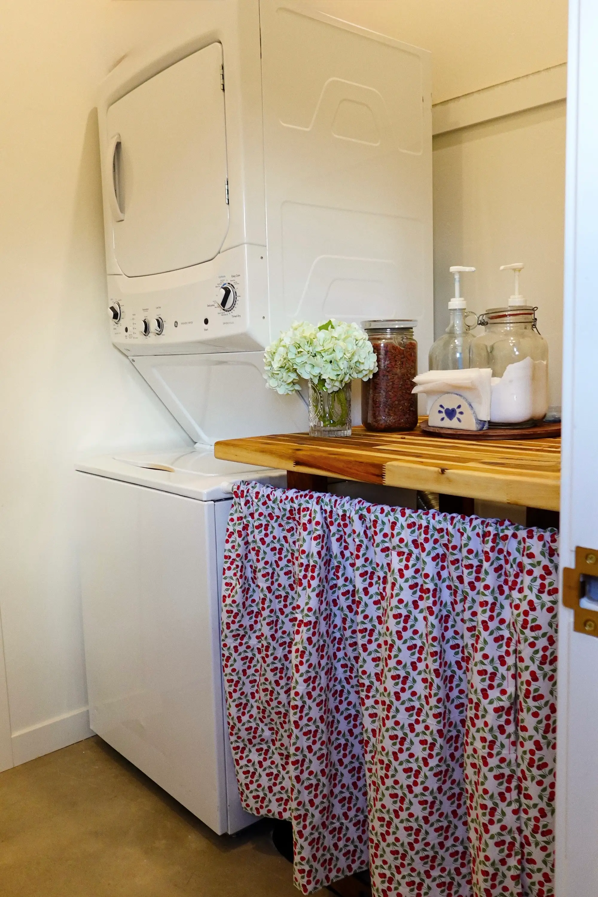 A laundry room with a wood counter next to it.