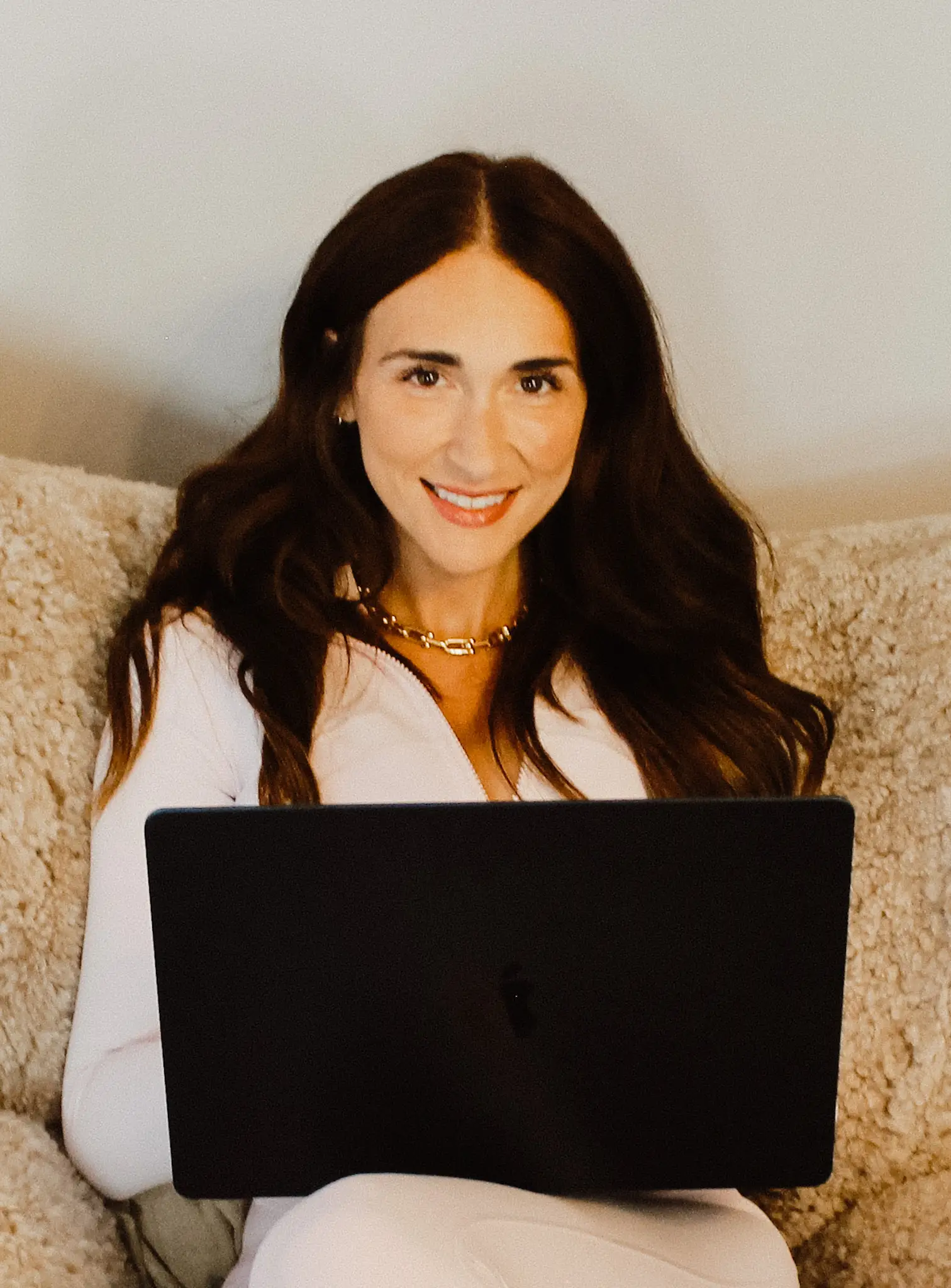 Women seated with a computer on her lap