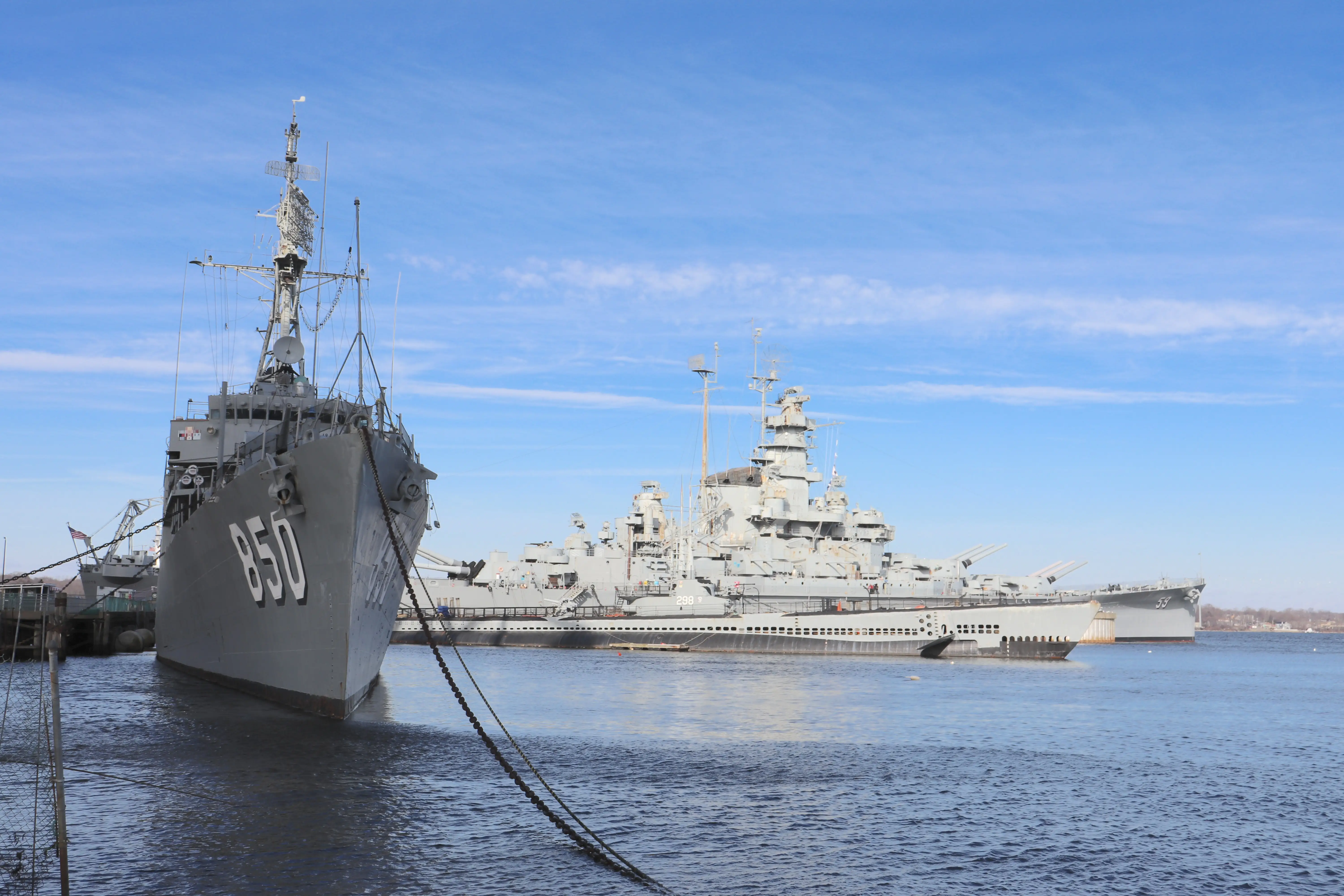 The USS Joseph P. Kennedy in the foreground, with the submarine USS Lionfish and the battleship USS Massachusetts in the background.