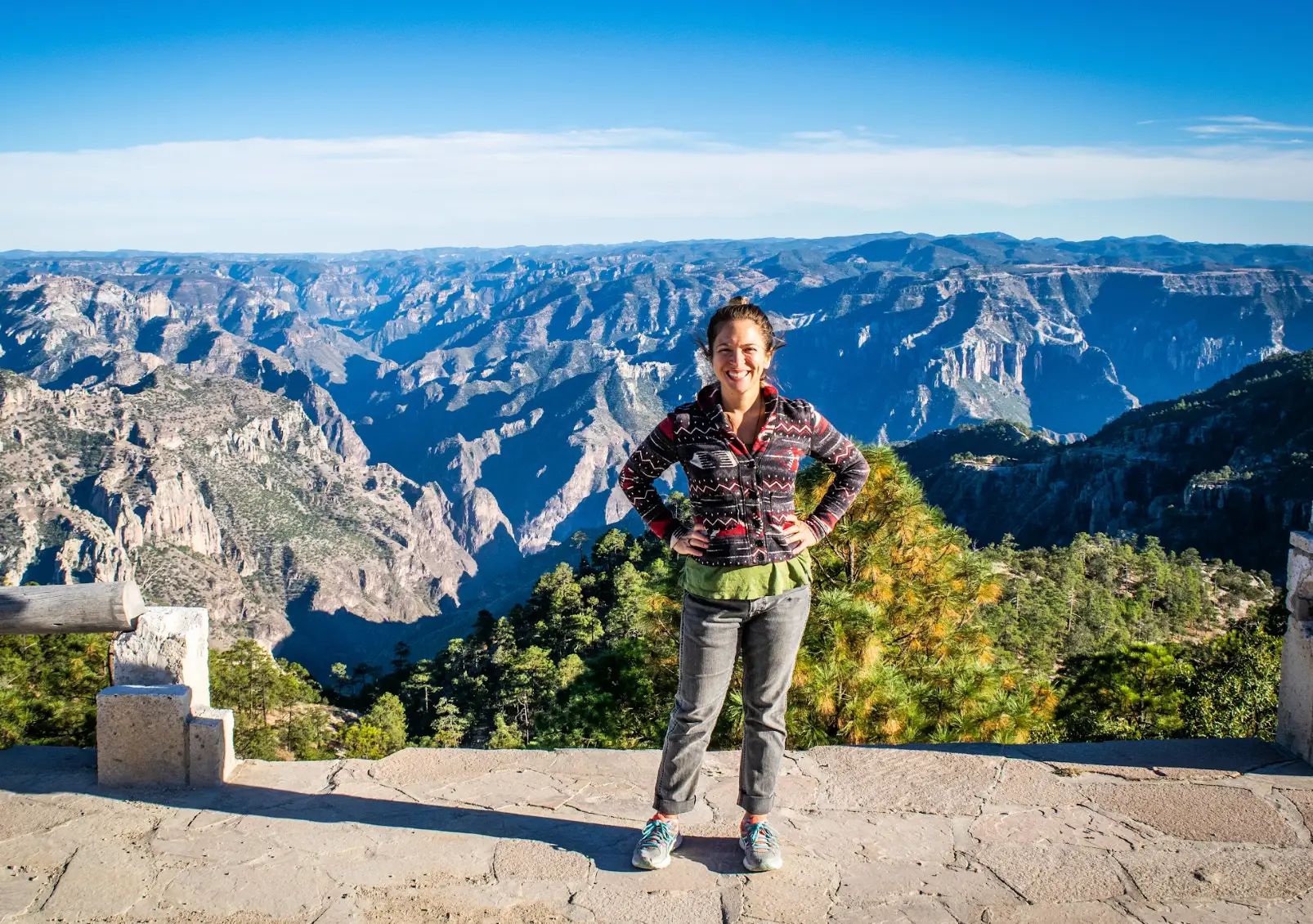 The writer standing in front of mountains in Mexico.