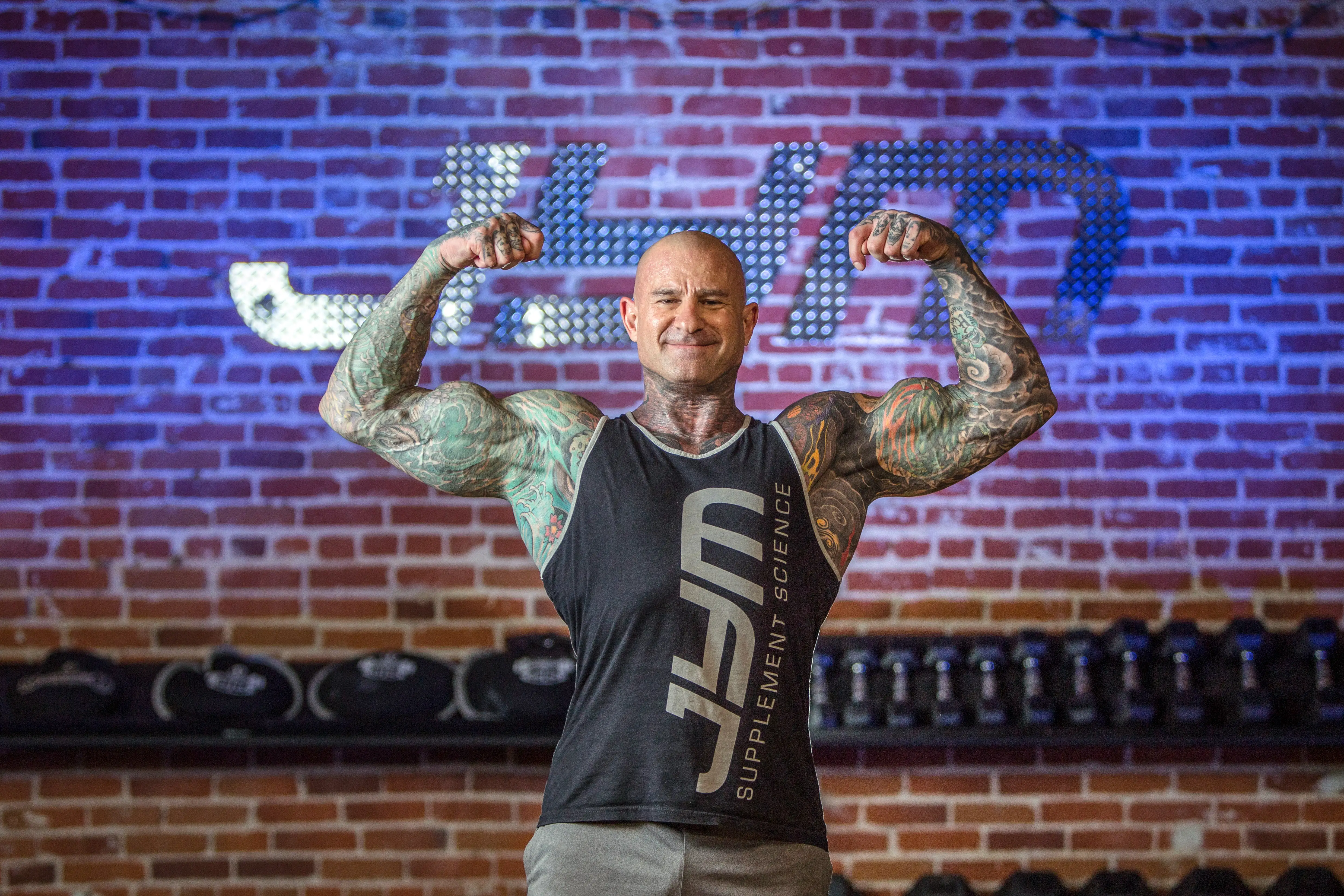 Bodybuilder and researcher Dr Jim Stoppani flexes in the gym