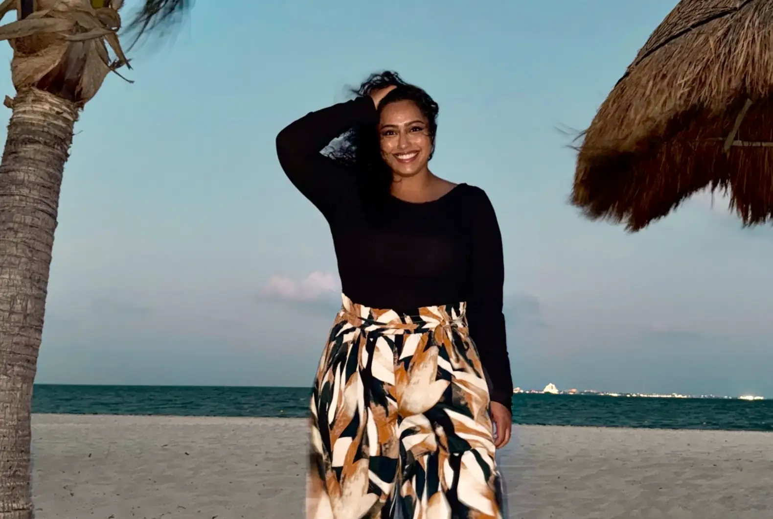 The writer posing on the beach in Cancún, Mexico.