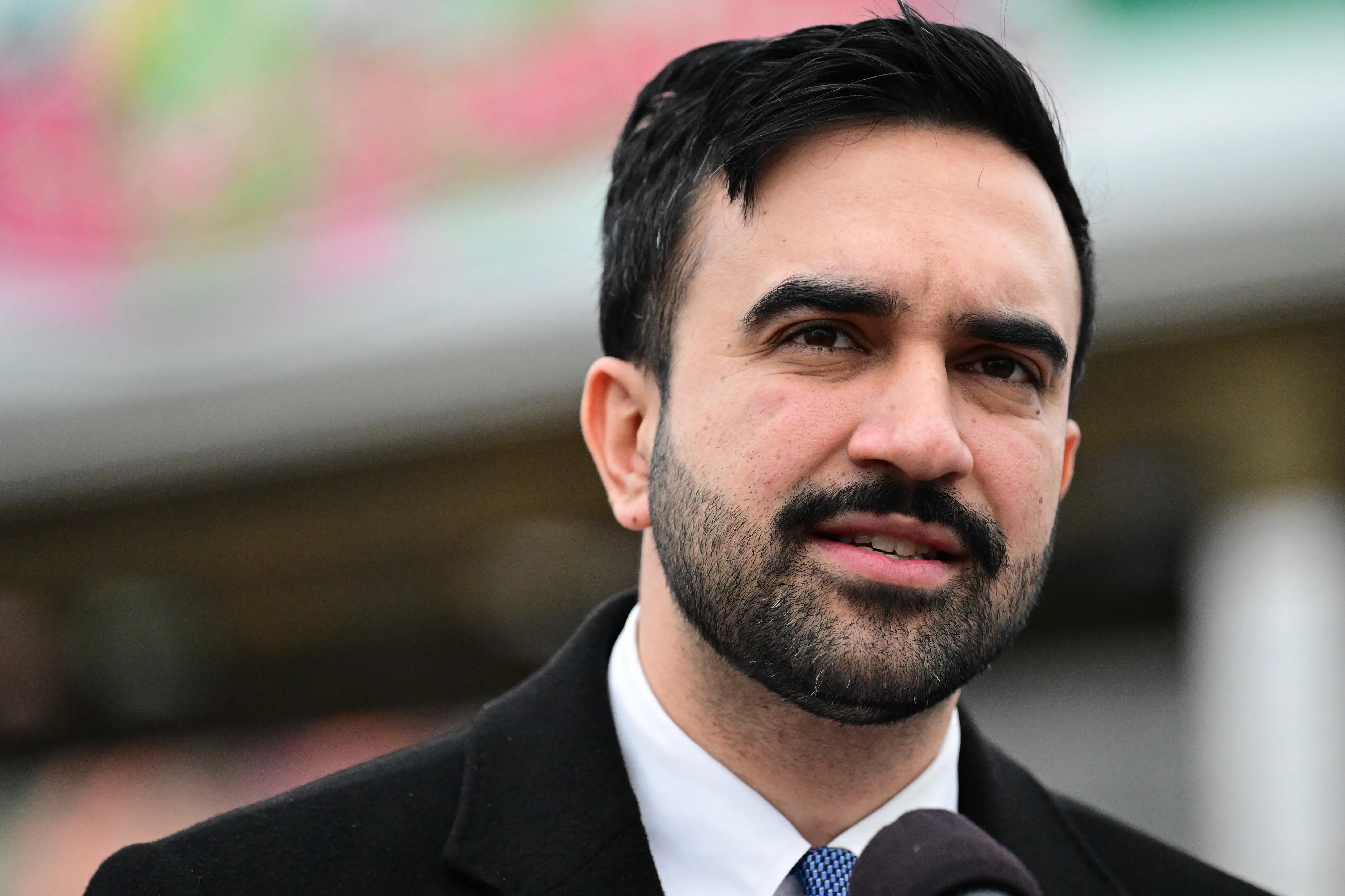 new york city mayor zohran mamdani speaking into a microphone