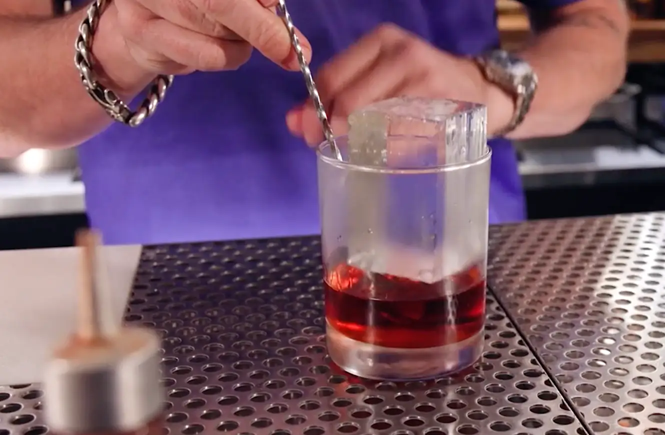 A giant cube of ice in a cocktail glass.