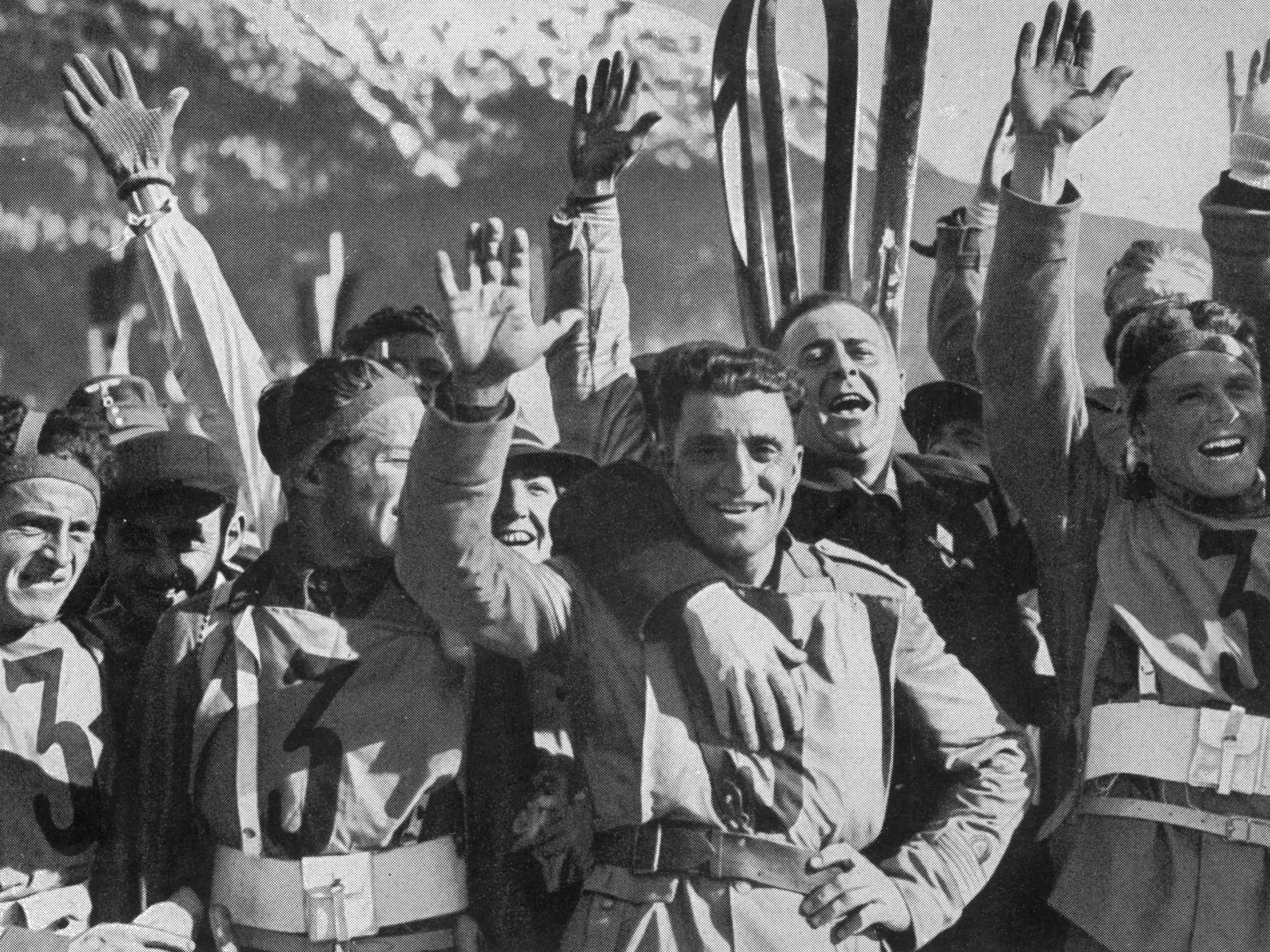 The Italian team celebrate their victory in the Military Patrol and are congratulated by their enthusiastic compatriots at the 1936 Olympic games.