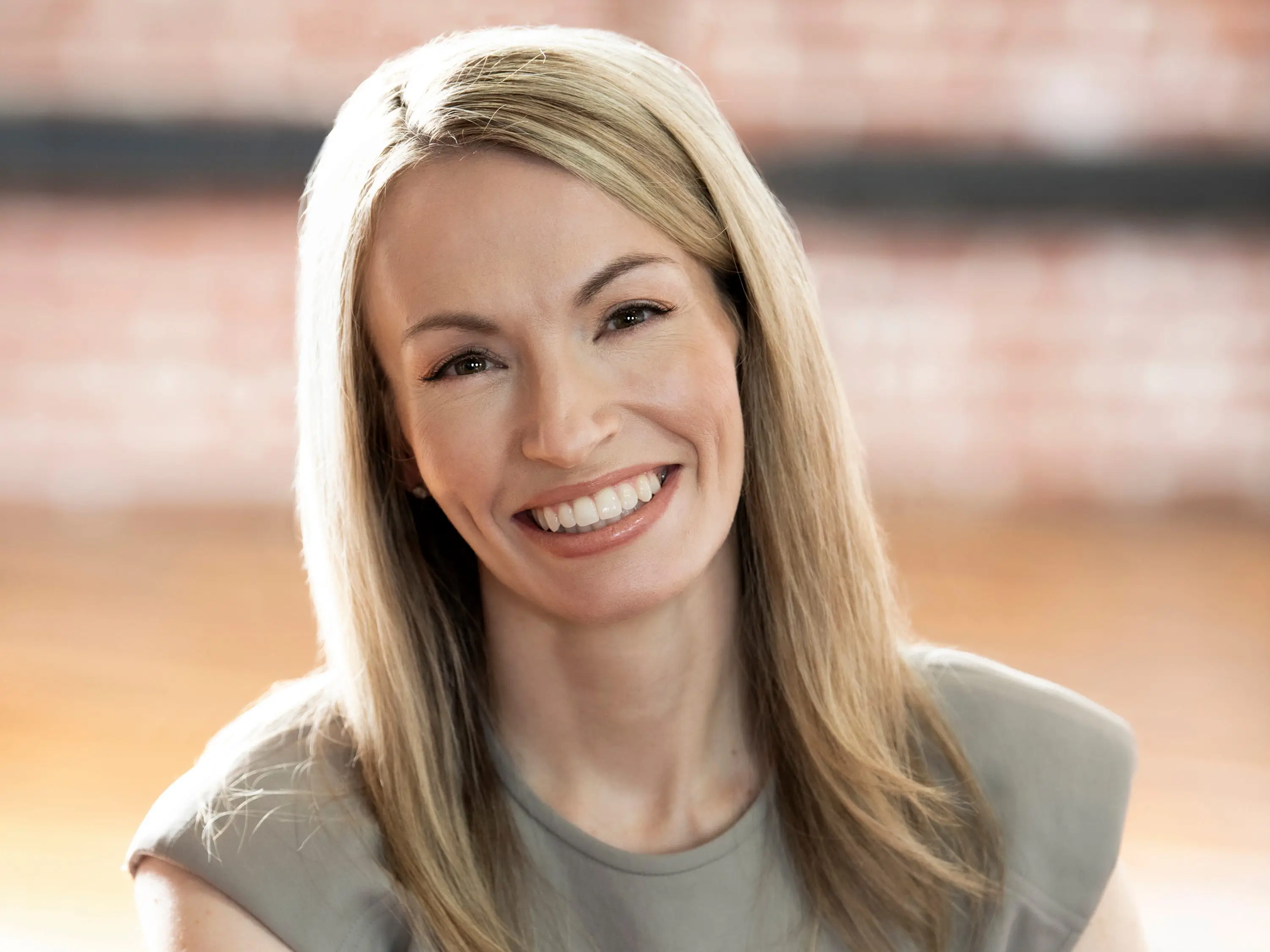 a doctor in business casual clothes sitting at a desk