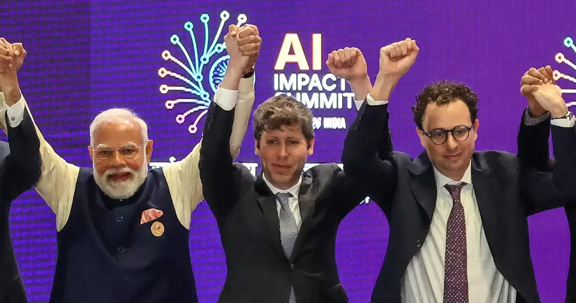 AI’s top leaders got corralled into holding hands. It made for a photo op for the ages.