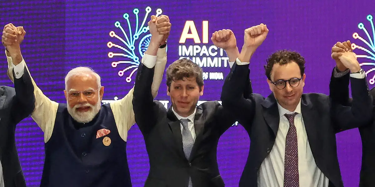 AI’s top leaders got corralled into holding hands. It made for a photo op for the ages.